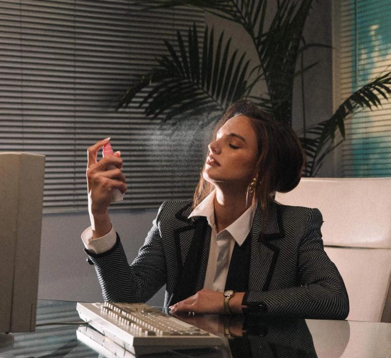 a woman in an office applying Super Spritz