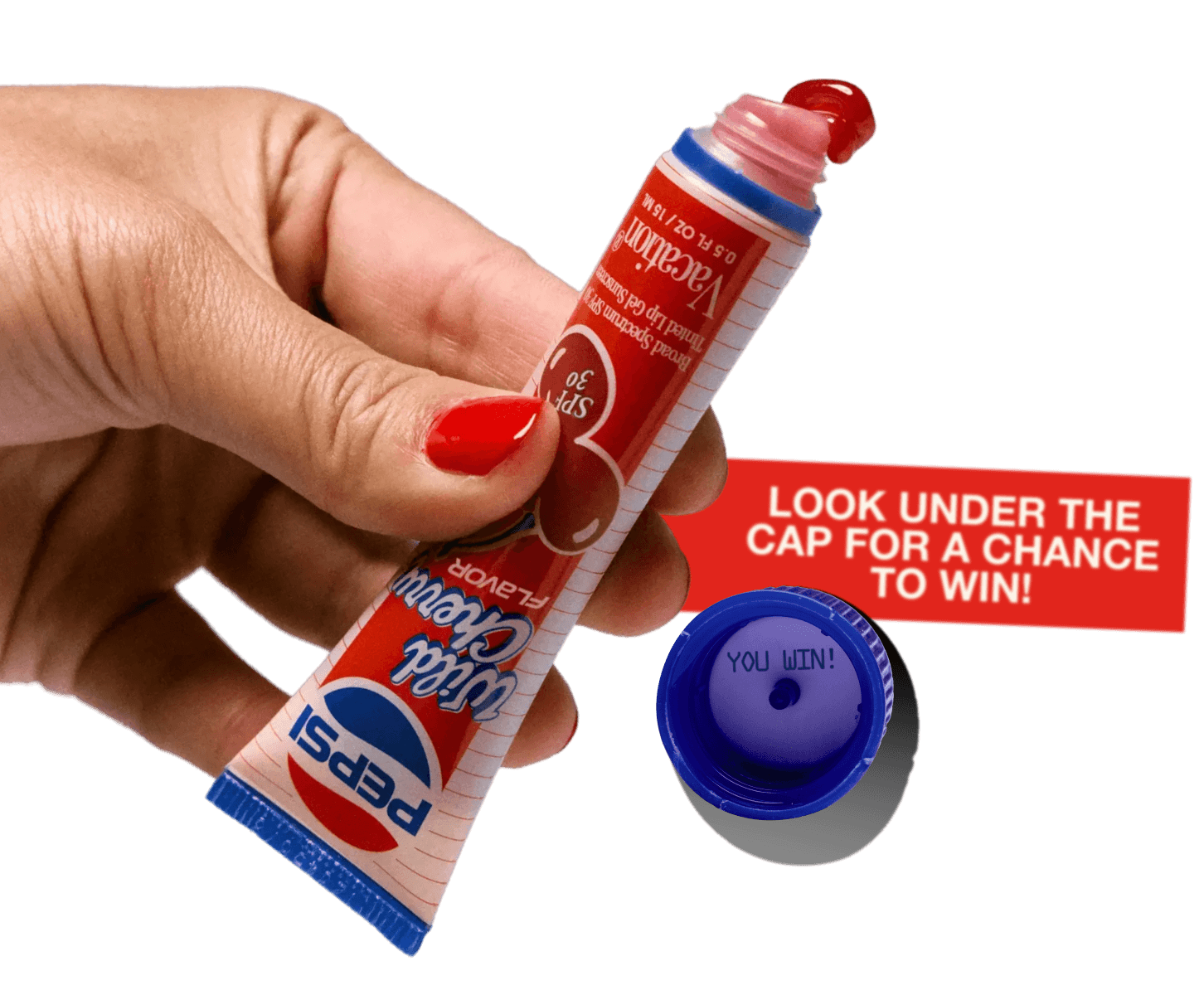 A hand holds a Wild Cherry Pepsi SPF 30 lip gloss tube, with red gloss emerging from the top. The detached blue cap reveals "YOU WIN!" inside, next to a red banner reading "LOOK UNDER THE CAP FOR A CHANCE TO WIN!".