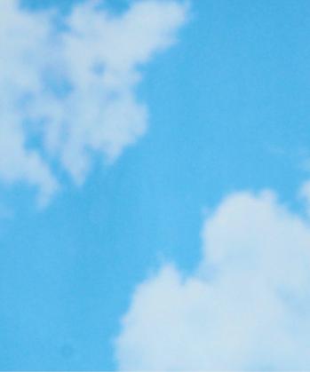 Light blue sky with soft white clouds