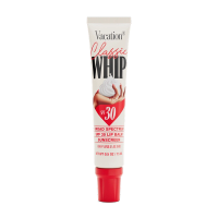White tube of Vacation Classic Whip SPF 30 lip balm with a hand holding whipped cream and a red cap.