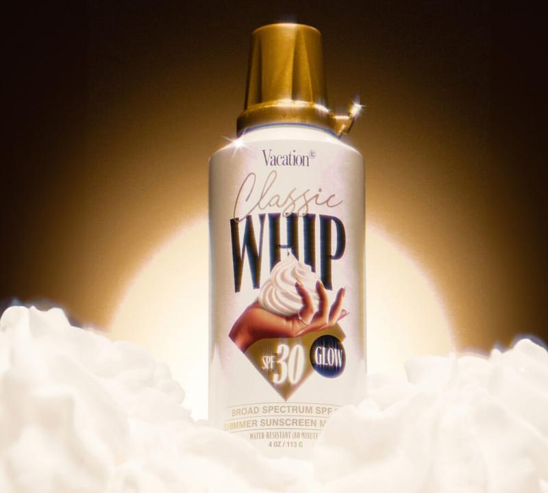 a bottle of classic whip sunscreen is sitting on top of a pile of clouds .