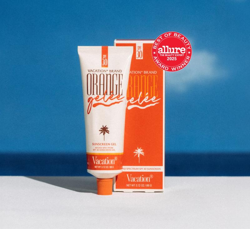 Vacation Brand Orange Gelée SPF 30 sunscreen gel tube and box, with a yellow "Buy 2 to unlock free shipping" sticker, set against a blue ocean scene.