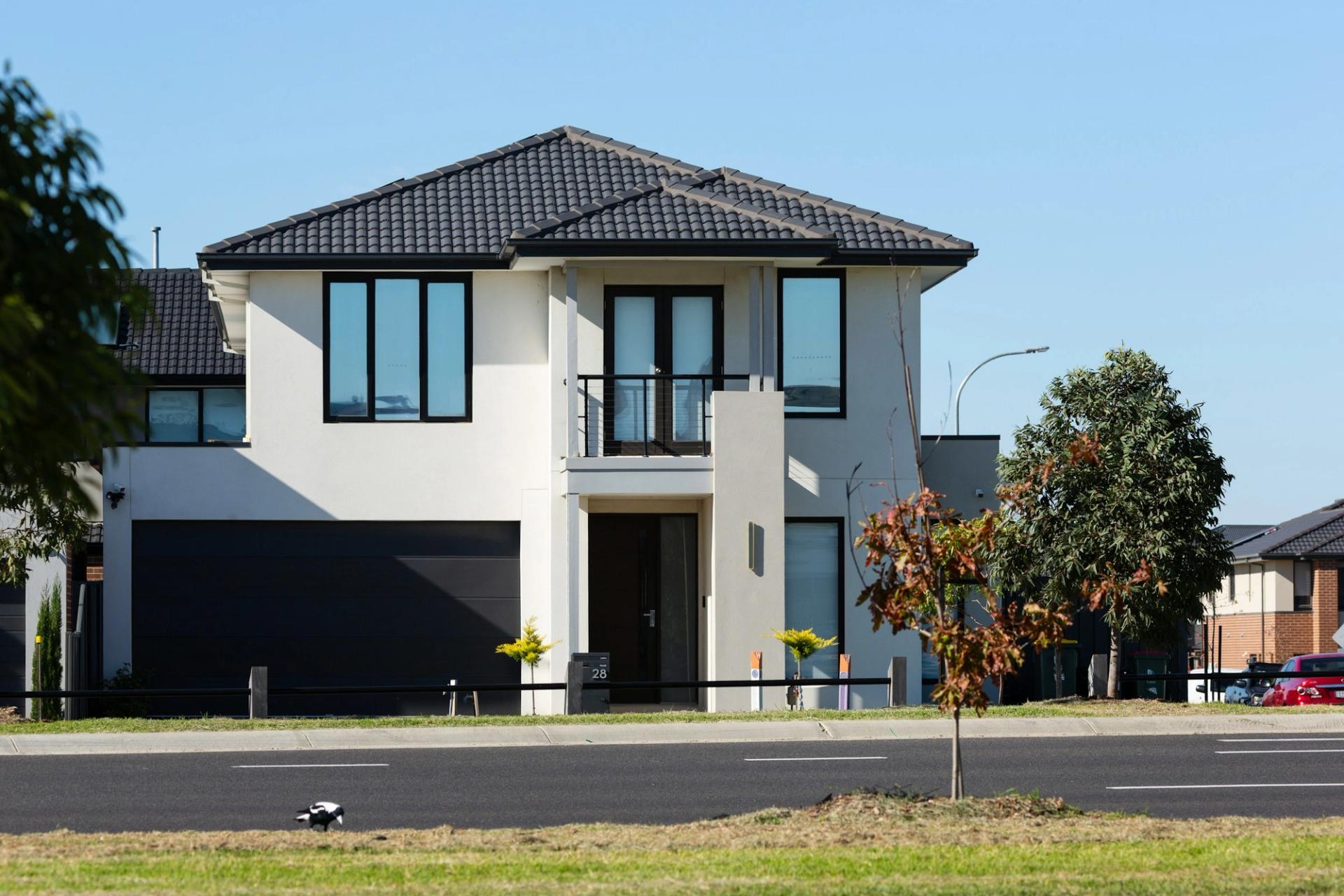 Modern two-story house with a dark garage door.
