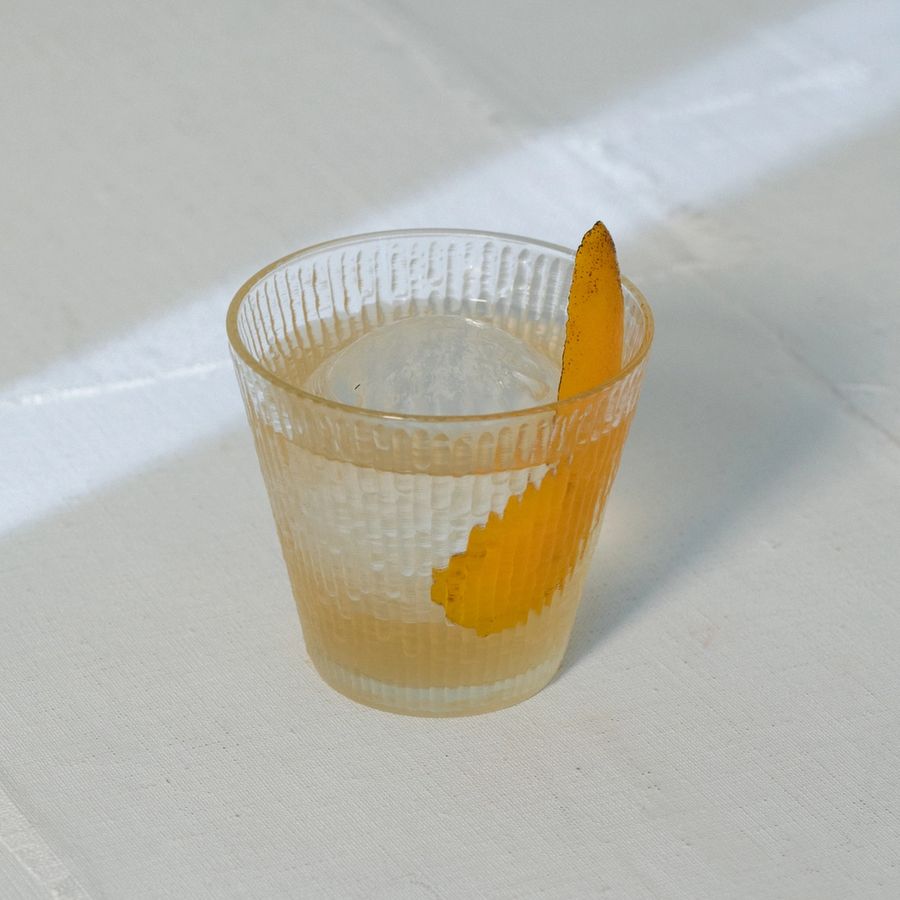 Rosaluna New Fashioned with flamed orange peel garnish