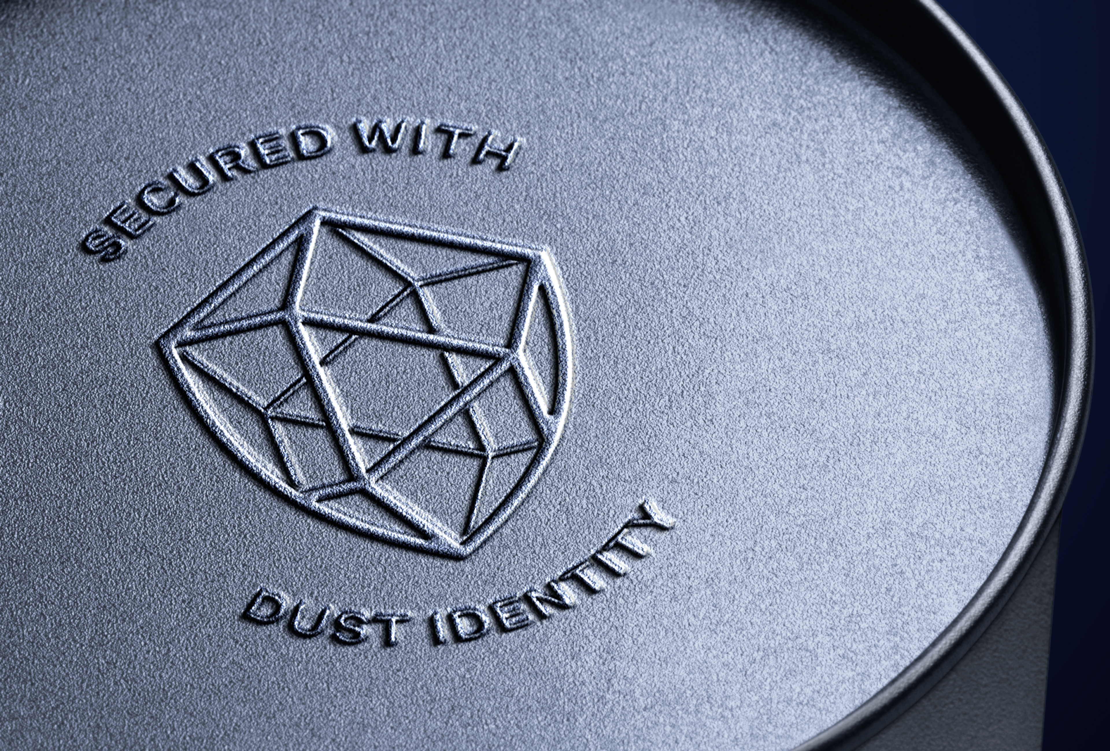 3d emboss, bottom of metal object, says "secured with Dust Identity" with the logo.. Copyright Cotton Design, Talia Cotton