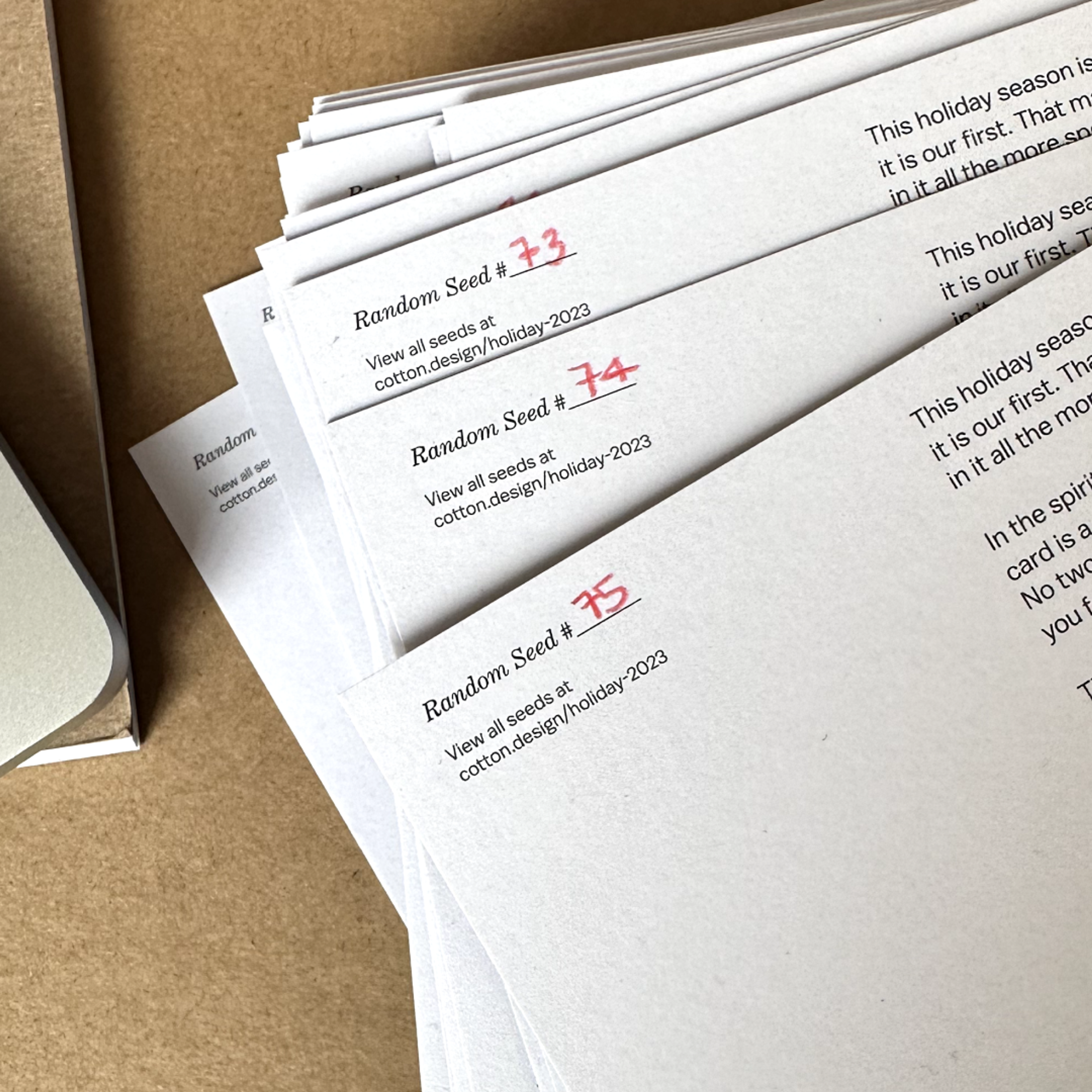 papers with text and a number written on them in red. Copyright Cotton Design, Talia Cotton