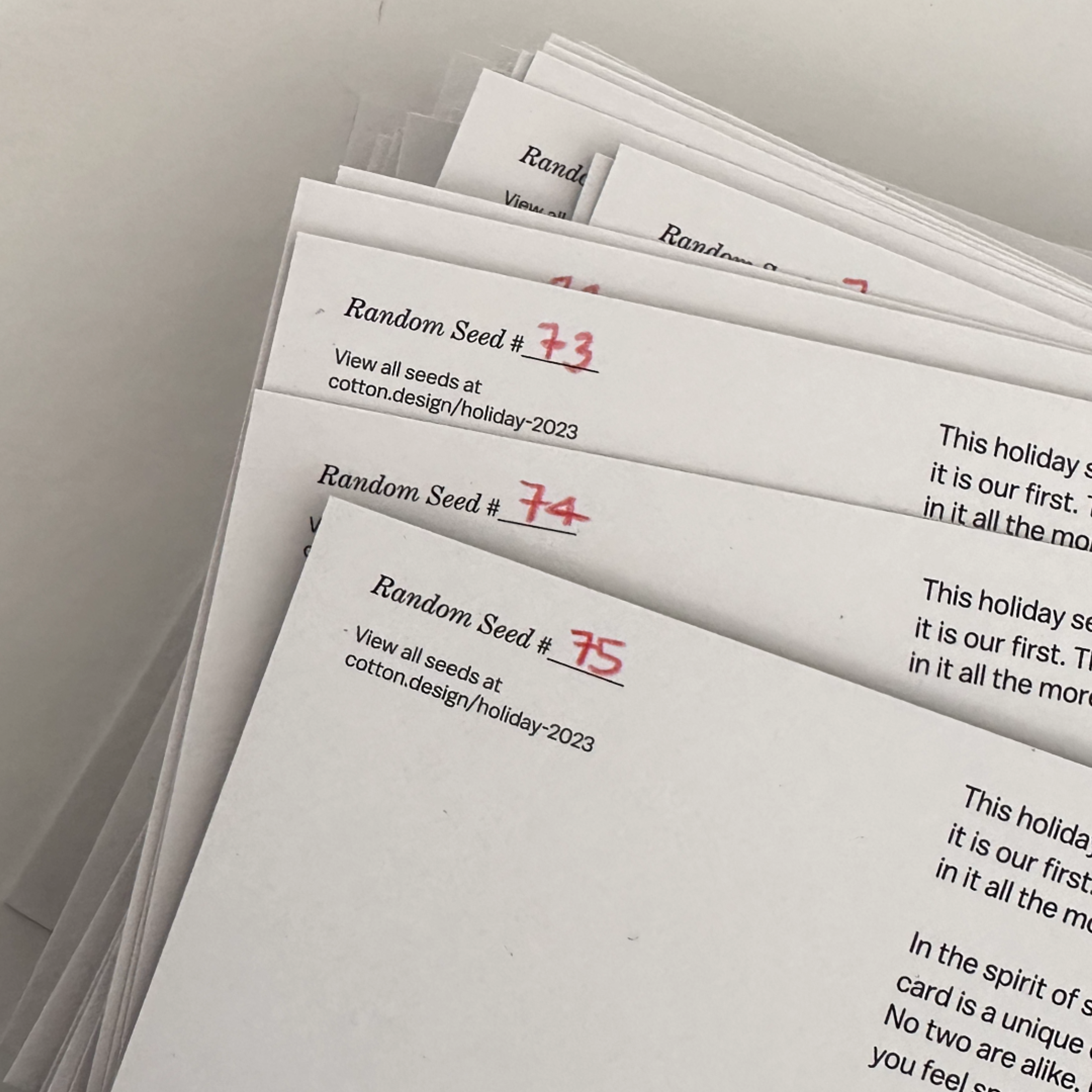 papers with text and a number written on them in red. Copyright Cotton Design, Talia Cotton