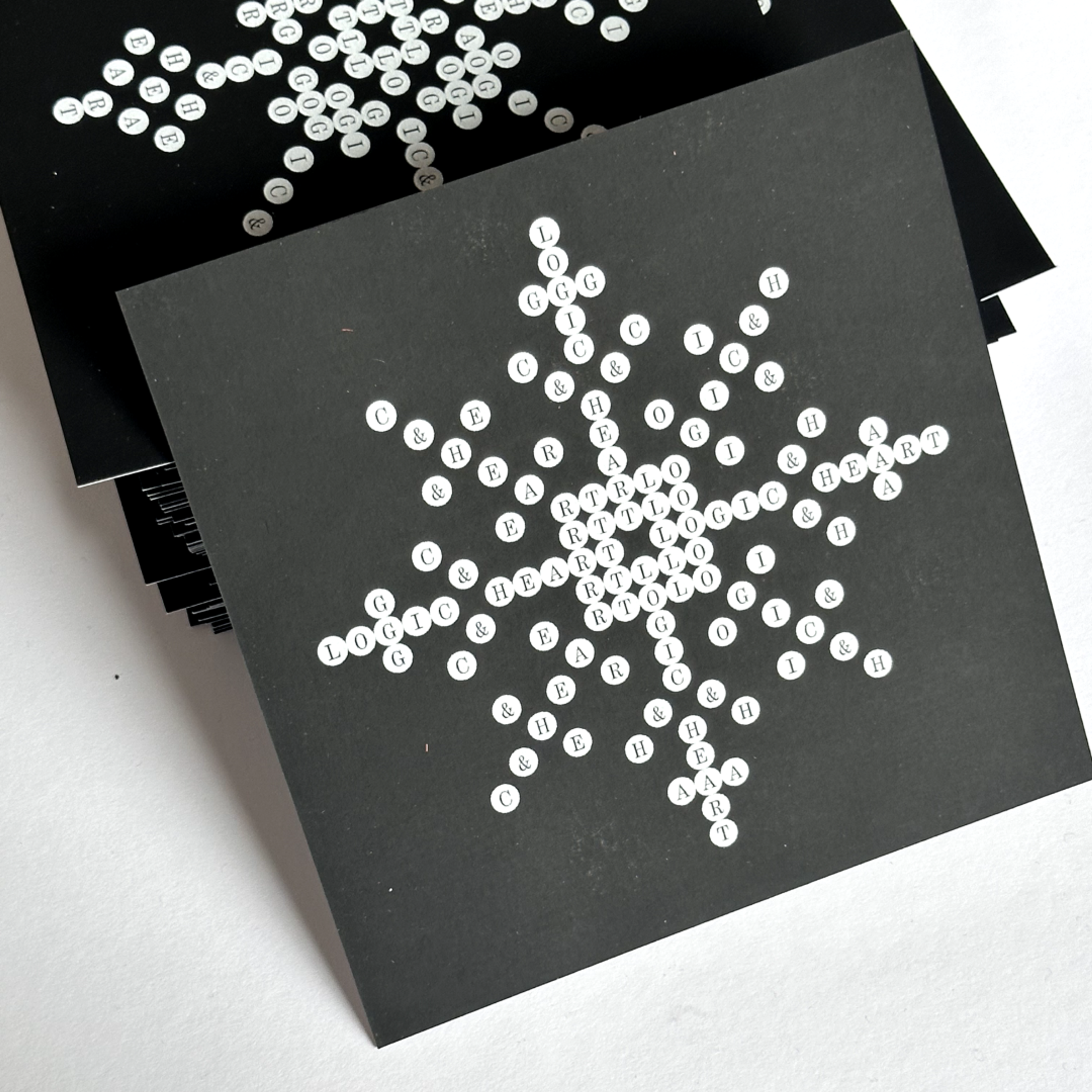 black cover book with white circles and letters in them. Copyright Cotton Design, Talia Cotton