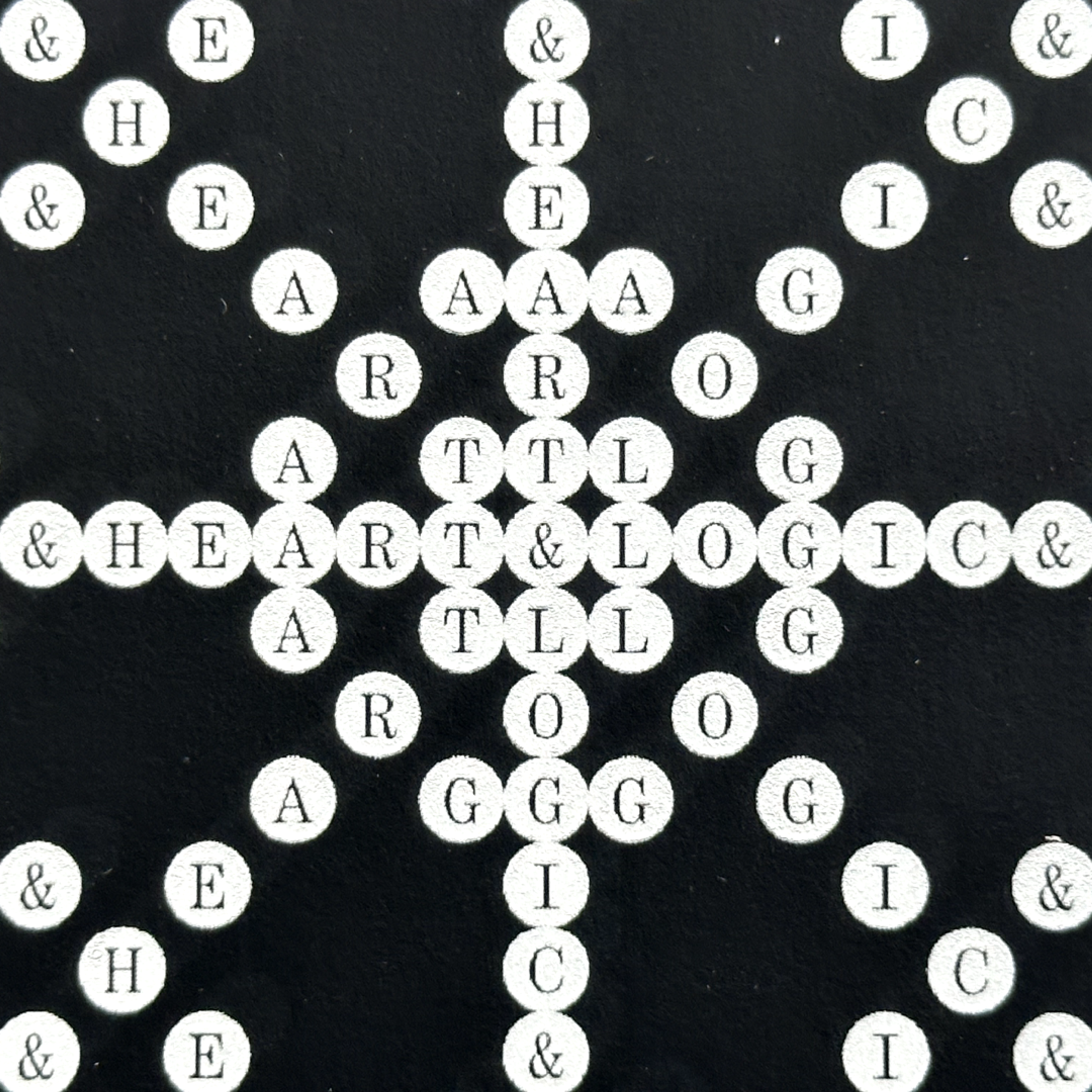 black image with white circles and letters in them. Copyright Cotton Design, Talia Cotton
