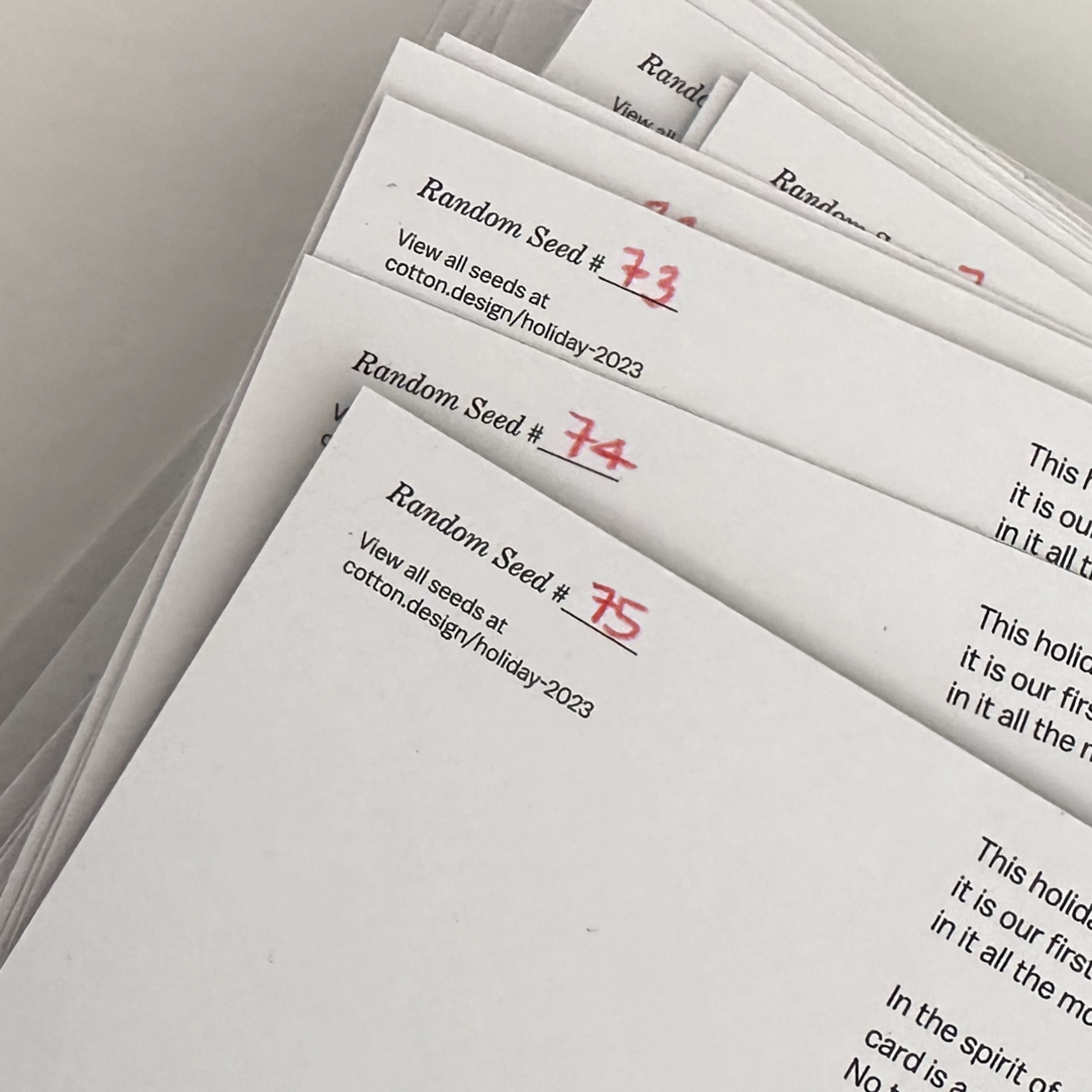 papers with text and a number written on them in red. Copyright Cotton Design, Talia Cotton