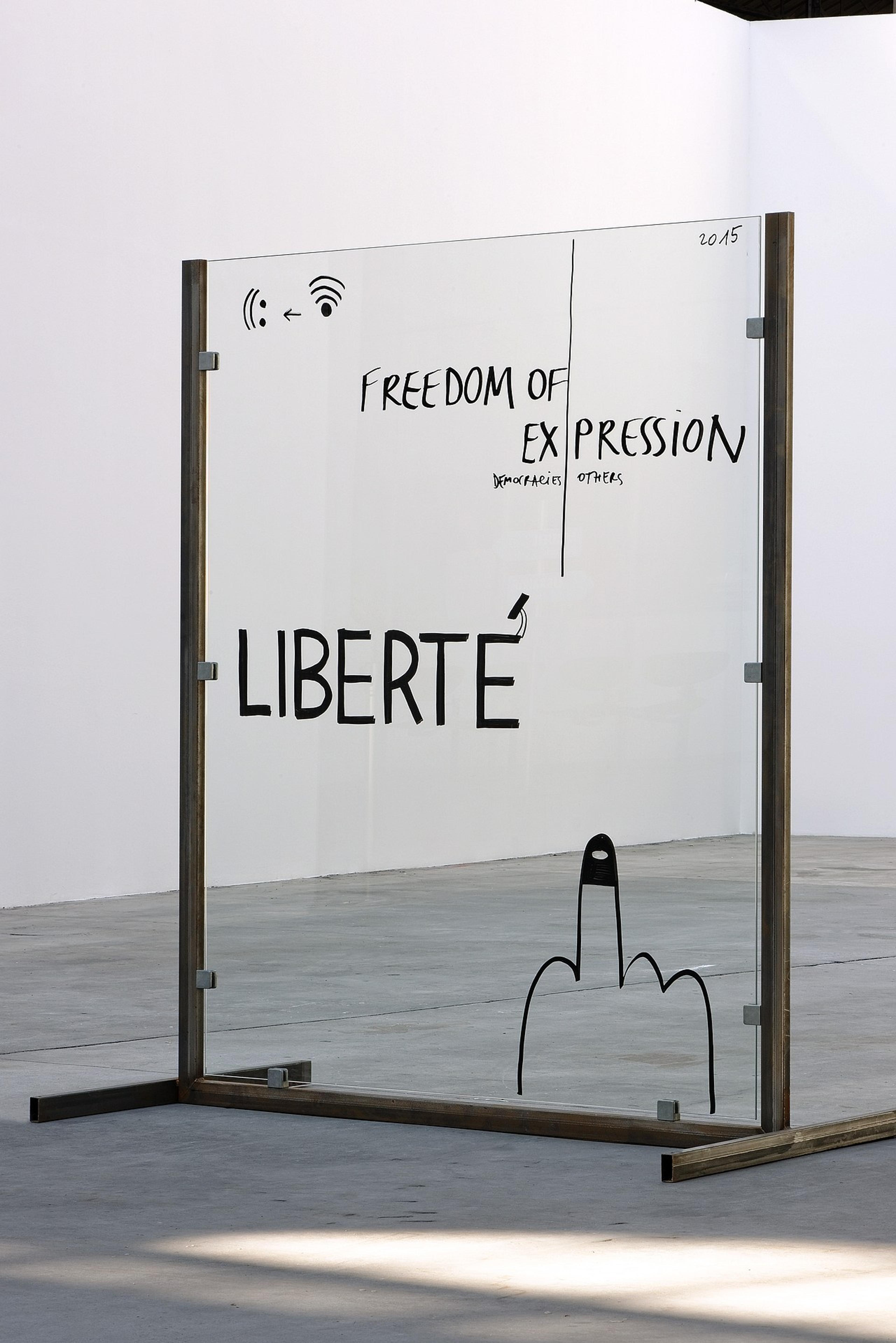 Reference for GBA Guilty by Association --  Liberte Freedom of Expression scribbled on glass in art gallery. Copyright Cotton Design, Talia Cotton