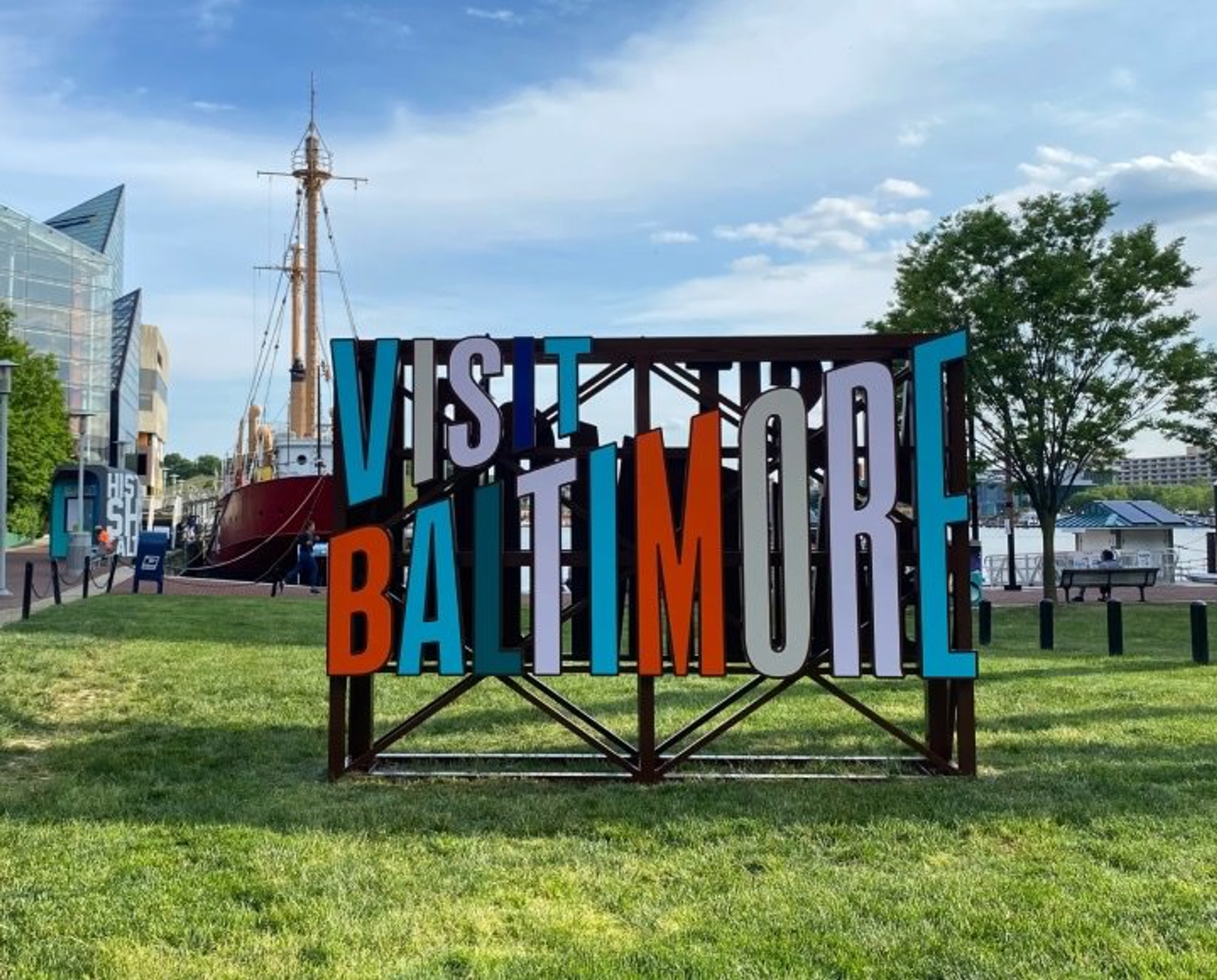 Visit Baltimore Sign in Grassy Patch