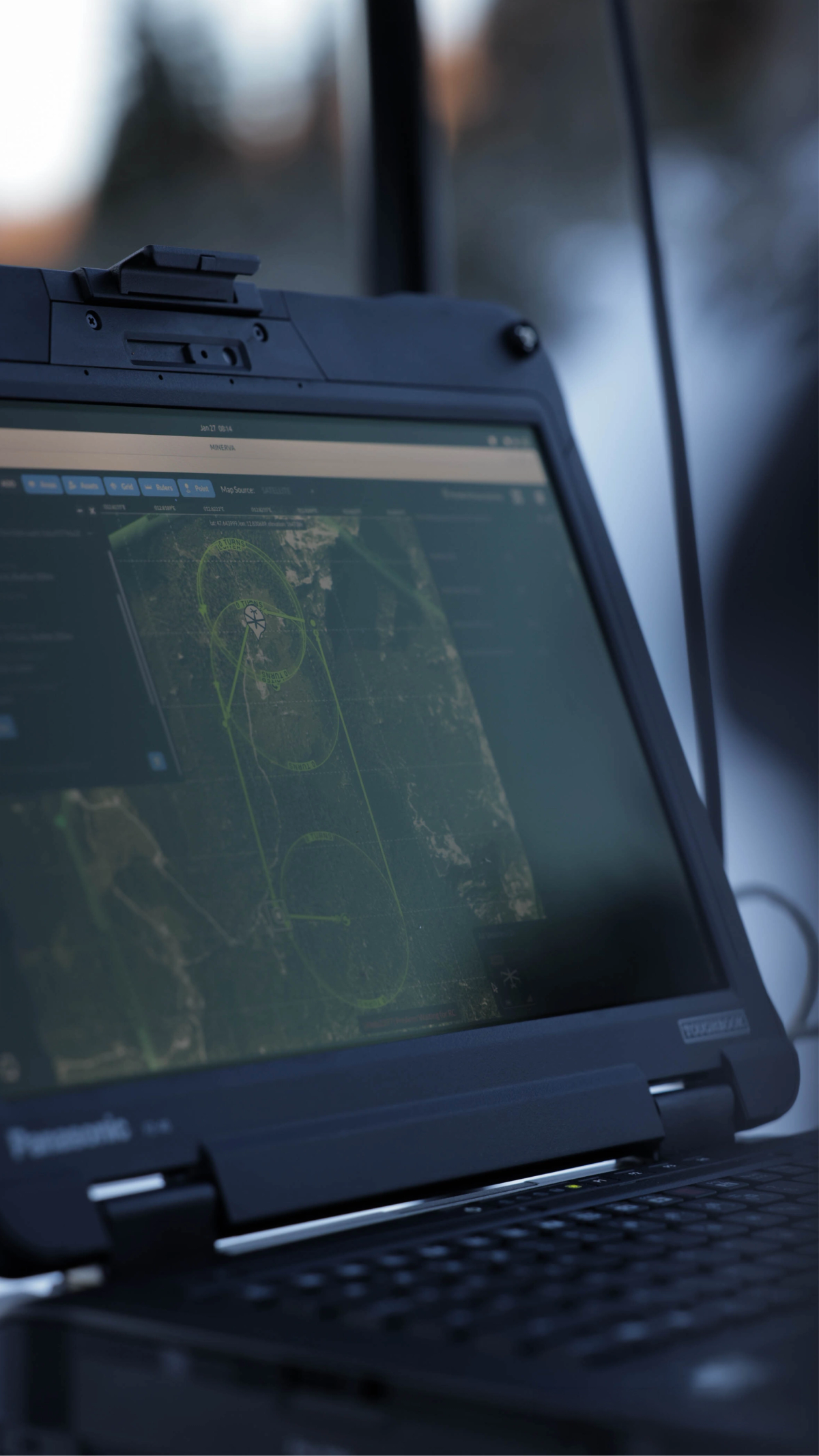 A Panasonic Toughbook laptop displays an aerial map with green lines and circles marking a survey or flight path.