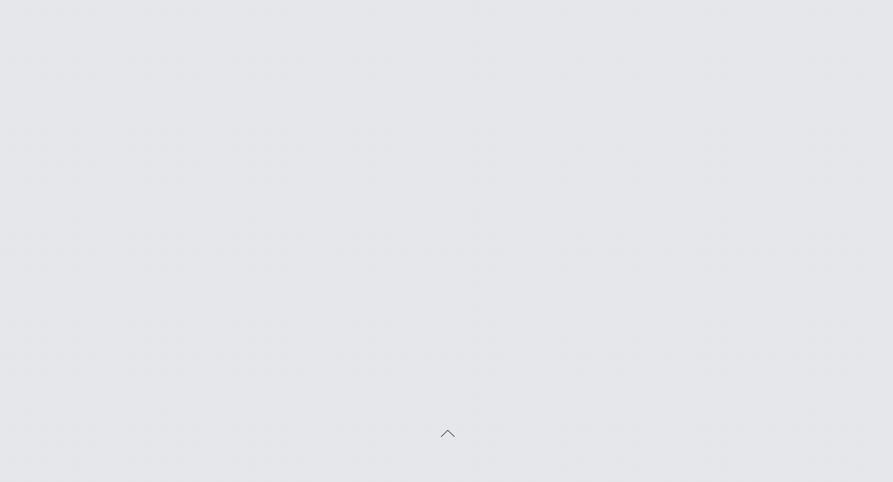 Upward-pointing caret icon on a light gray background.