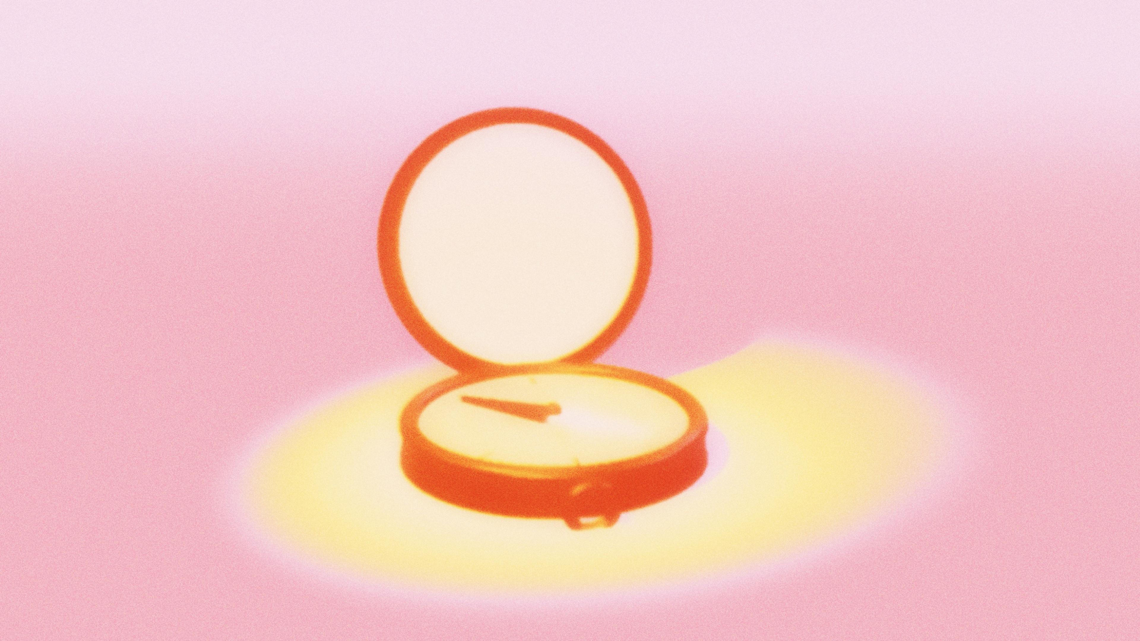 An open pocket compass on the floor in soft warm light, its needle settling on a direction.