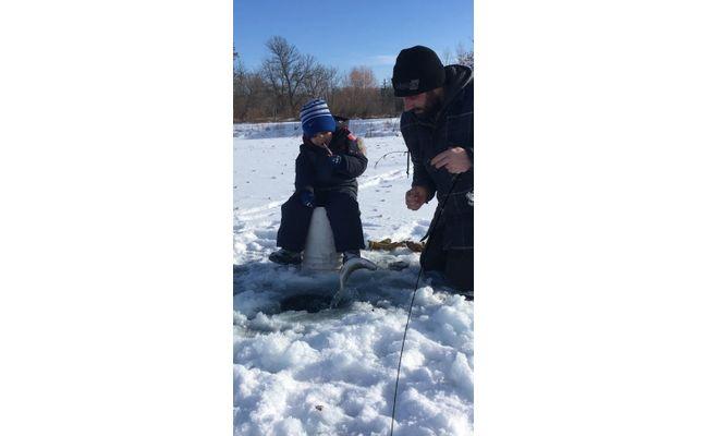 Blair and Jax ice fishing on their Koenders-aerated pond in Manitoba