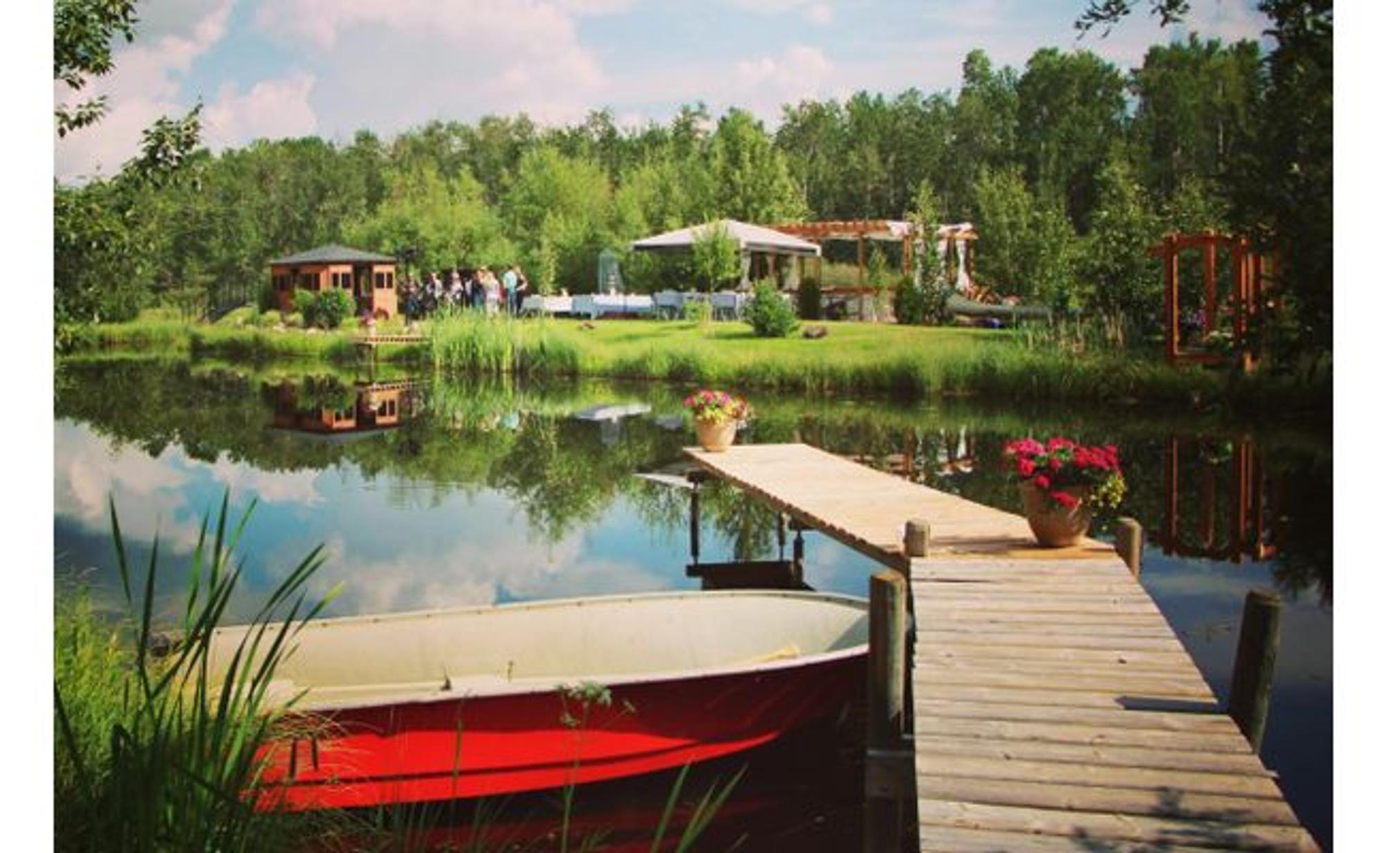 Dick's landscaped pond with a red canoe and dock