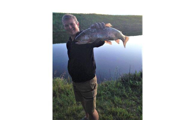John holding a rainbow trout from his aerated pond near Calgary, Alberta