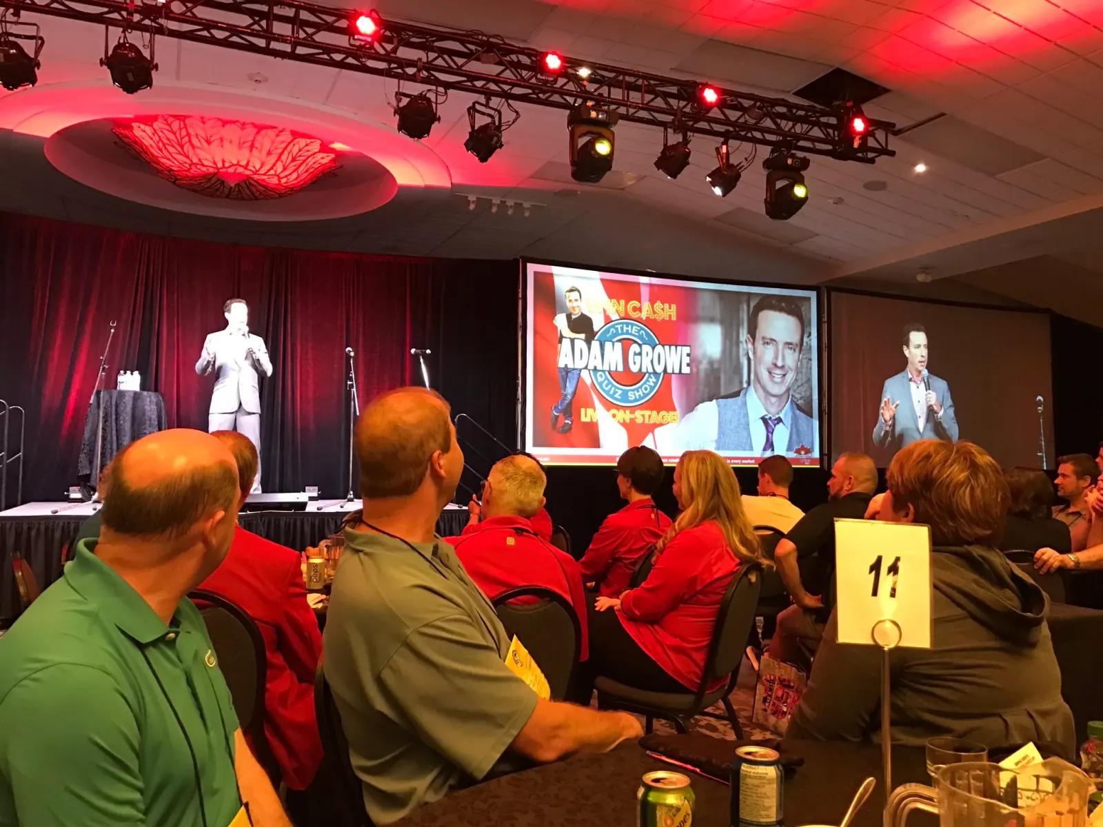 Event MC and Game Show host, Adam Growe on stage at a corporate event in Toronto.