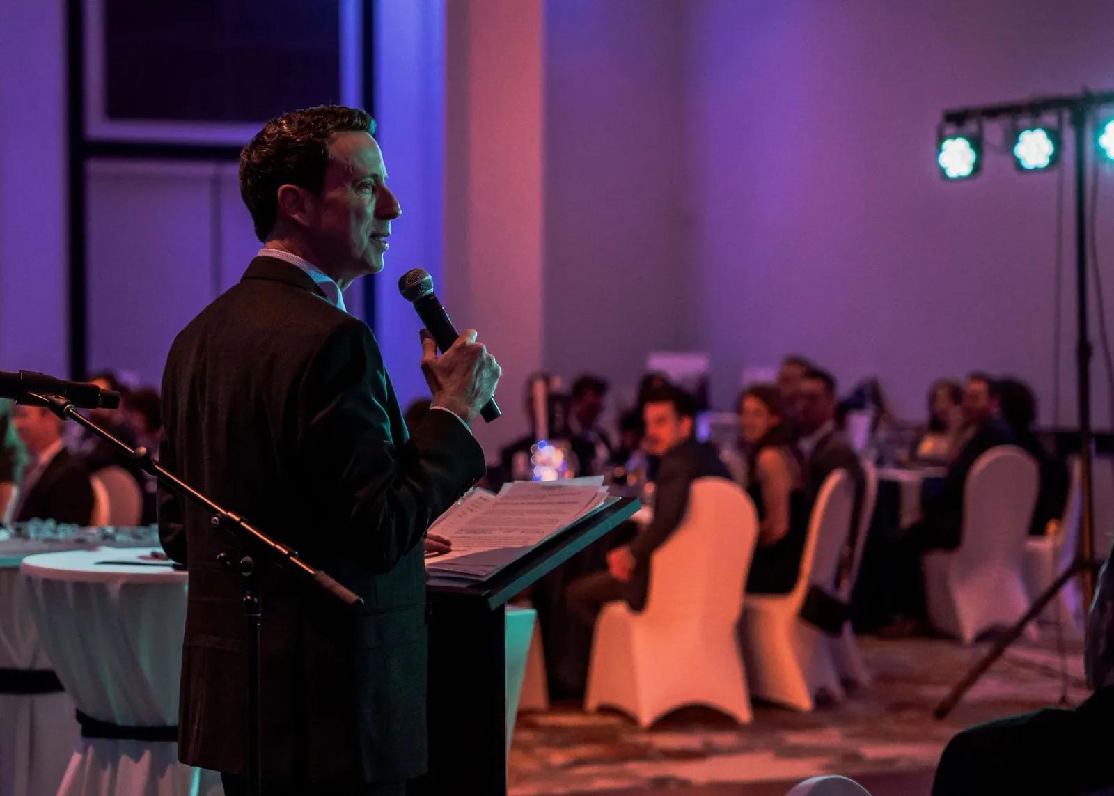 event host warming up the crowd at a corporate event in Toronto