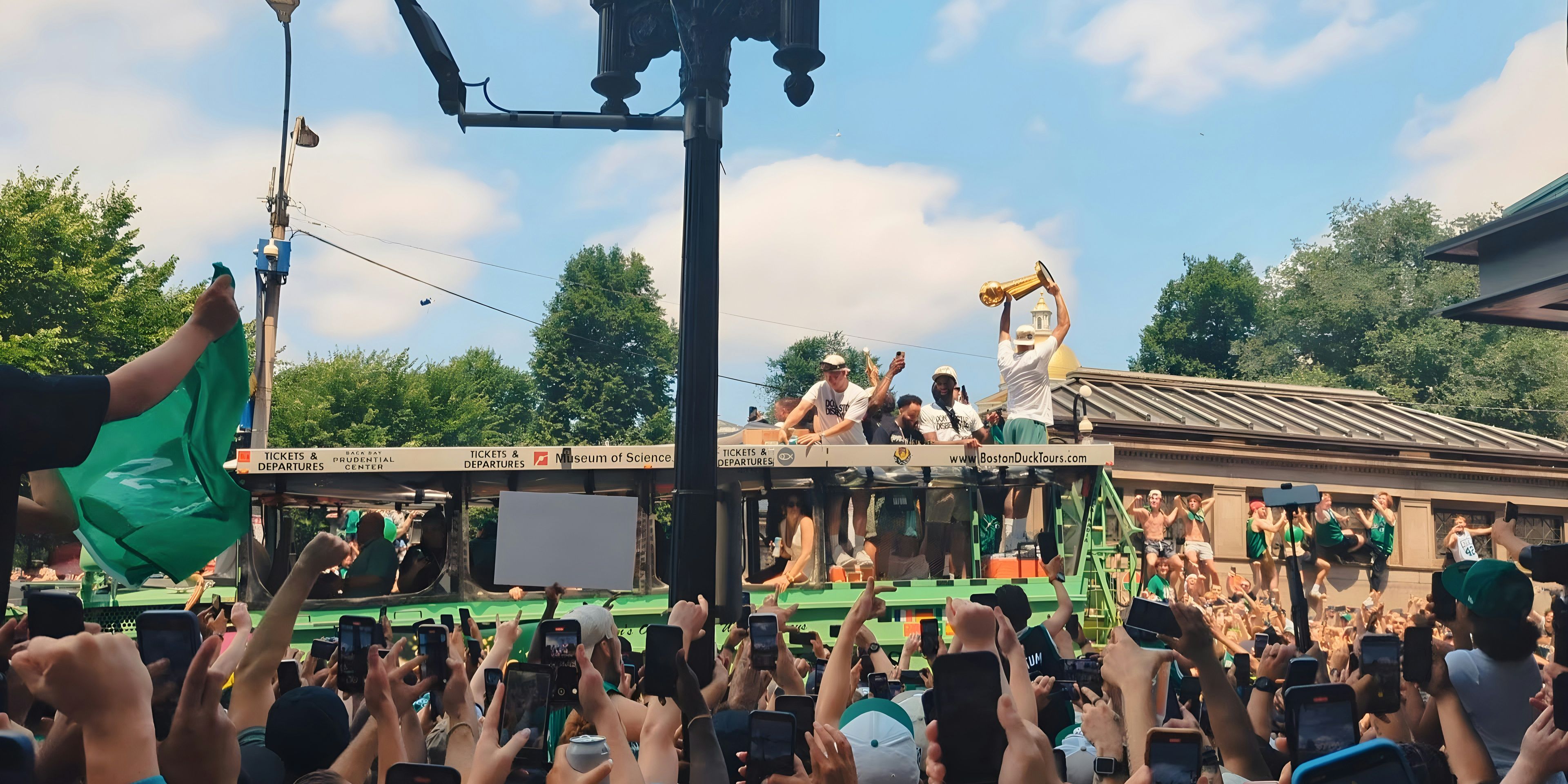 Jayson Tatum with the Larry O'Brien Trophy in front of passionate fans at the Celtics Championship Parade on Friday, June 21, 2024.