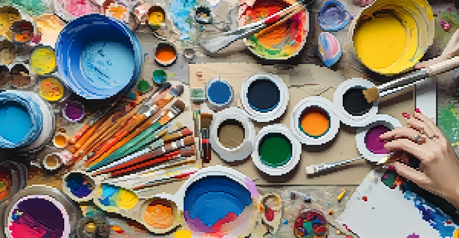 An overhead view of a table filled with mixed media art supplies and hands creating a colorful artwork.