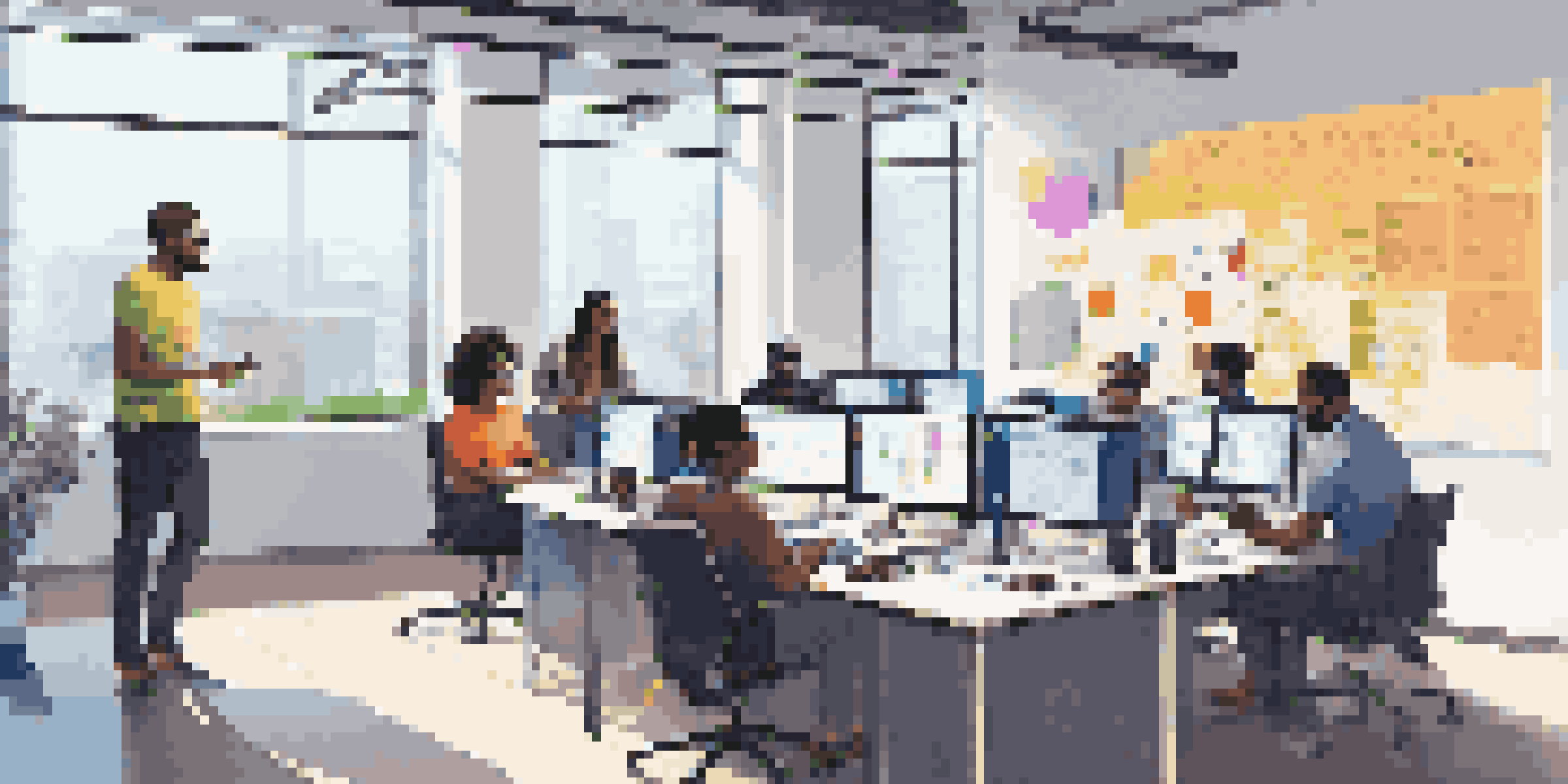 A diverse team of software developers and IT operations professionals brainstorming in a modern workspace filled with technology and colorful sticky notes.