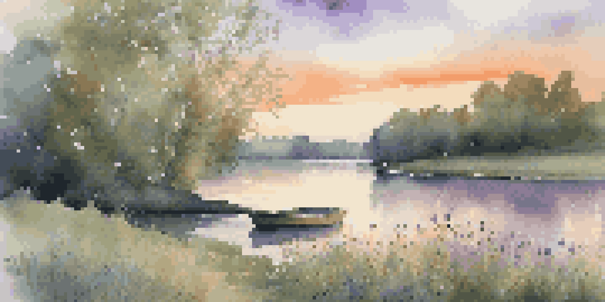 A tranquil riverbank scene during sunset, with blooming wildflowers and a small boat on the water.