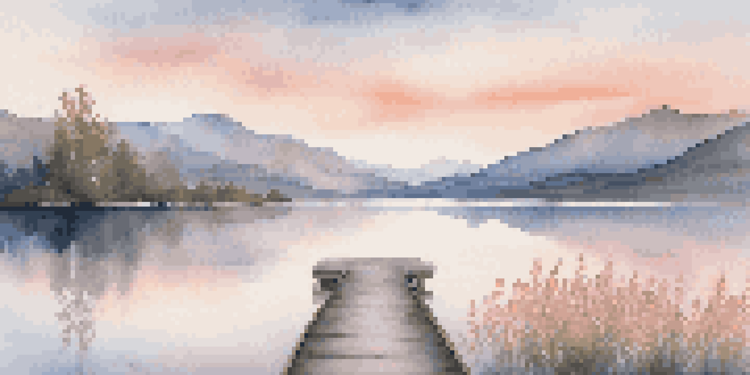 A peaceful lake scene at sunrise, with mountains in the background and a wooden dock in the foreground.