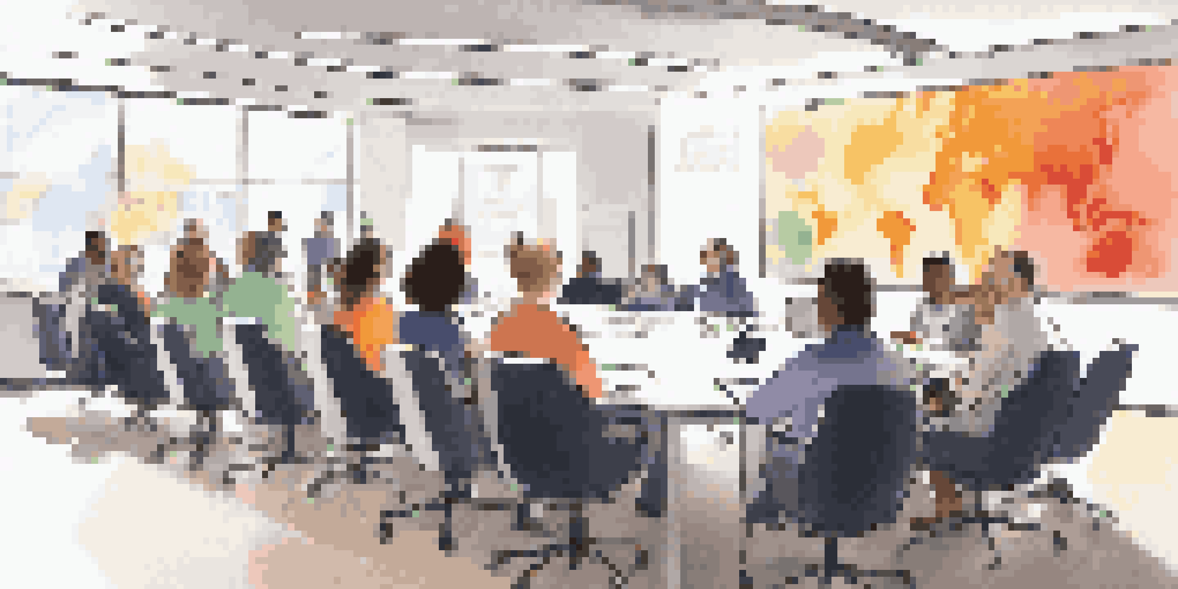 A diverse group of employees participating in a data privacy training session in a modern, well-lit workspace.