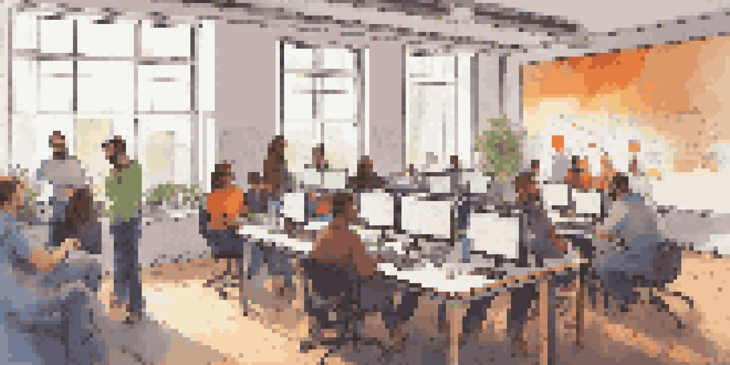 A community gathering of diverse developers collaborating on open source software, with laptops, whiteboards, and posters in a well-lit room.