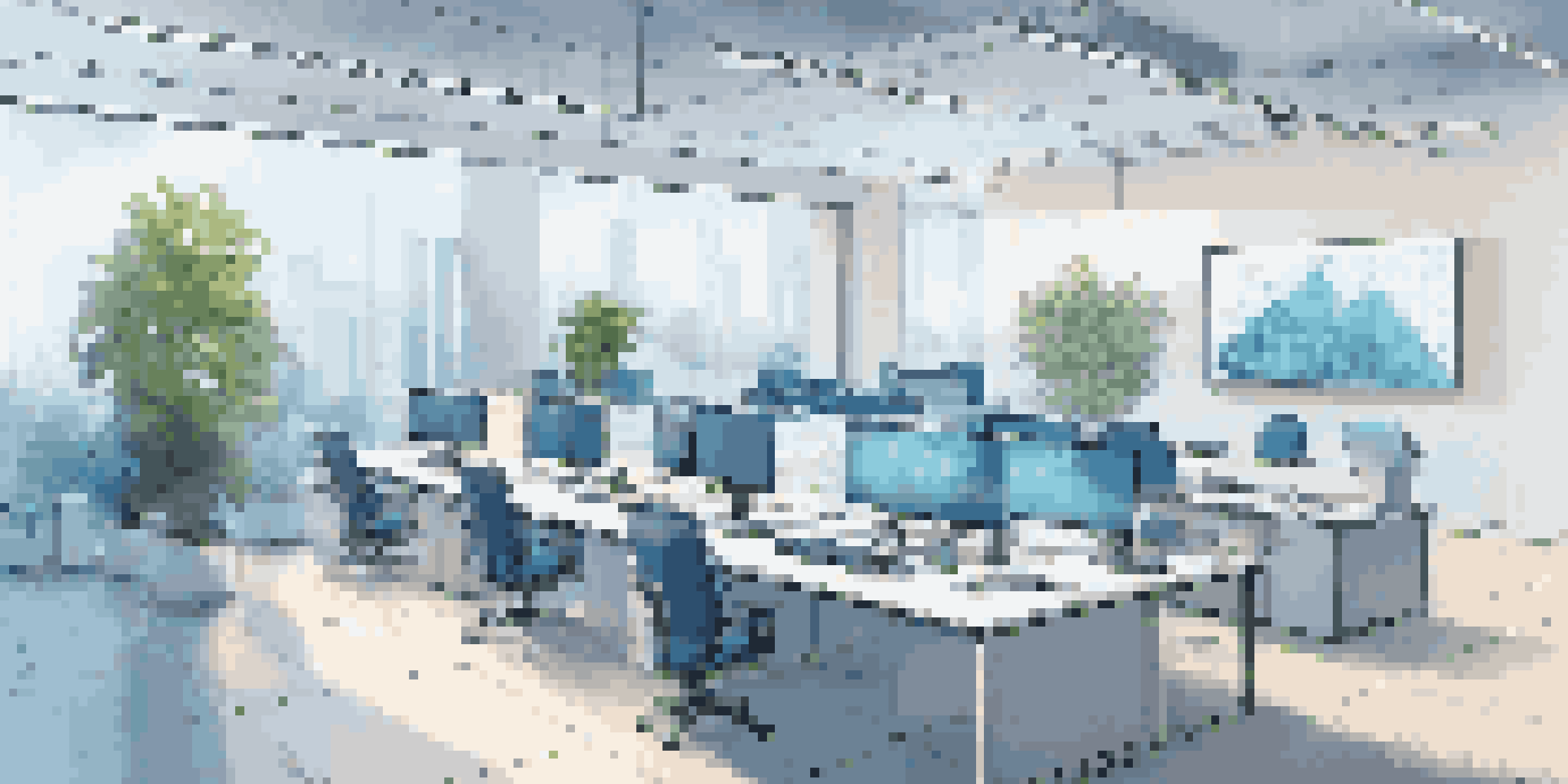 A bright office space featuring a digital screen showing a blockchain network diagram, with plants and a modern design.