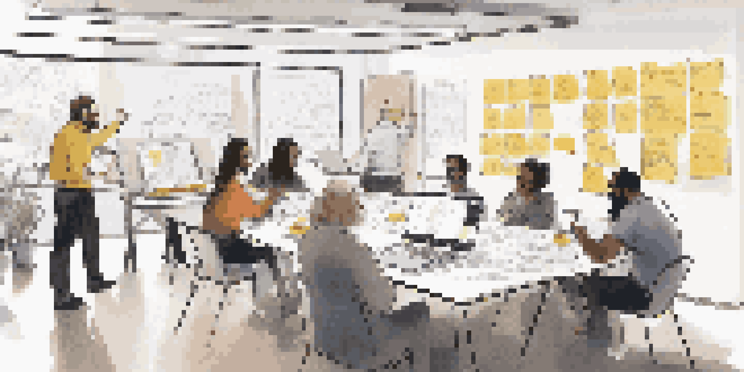 A diverse team collaborating in a bright workshop, surrounded by design materials and user journey maps.