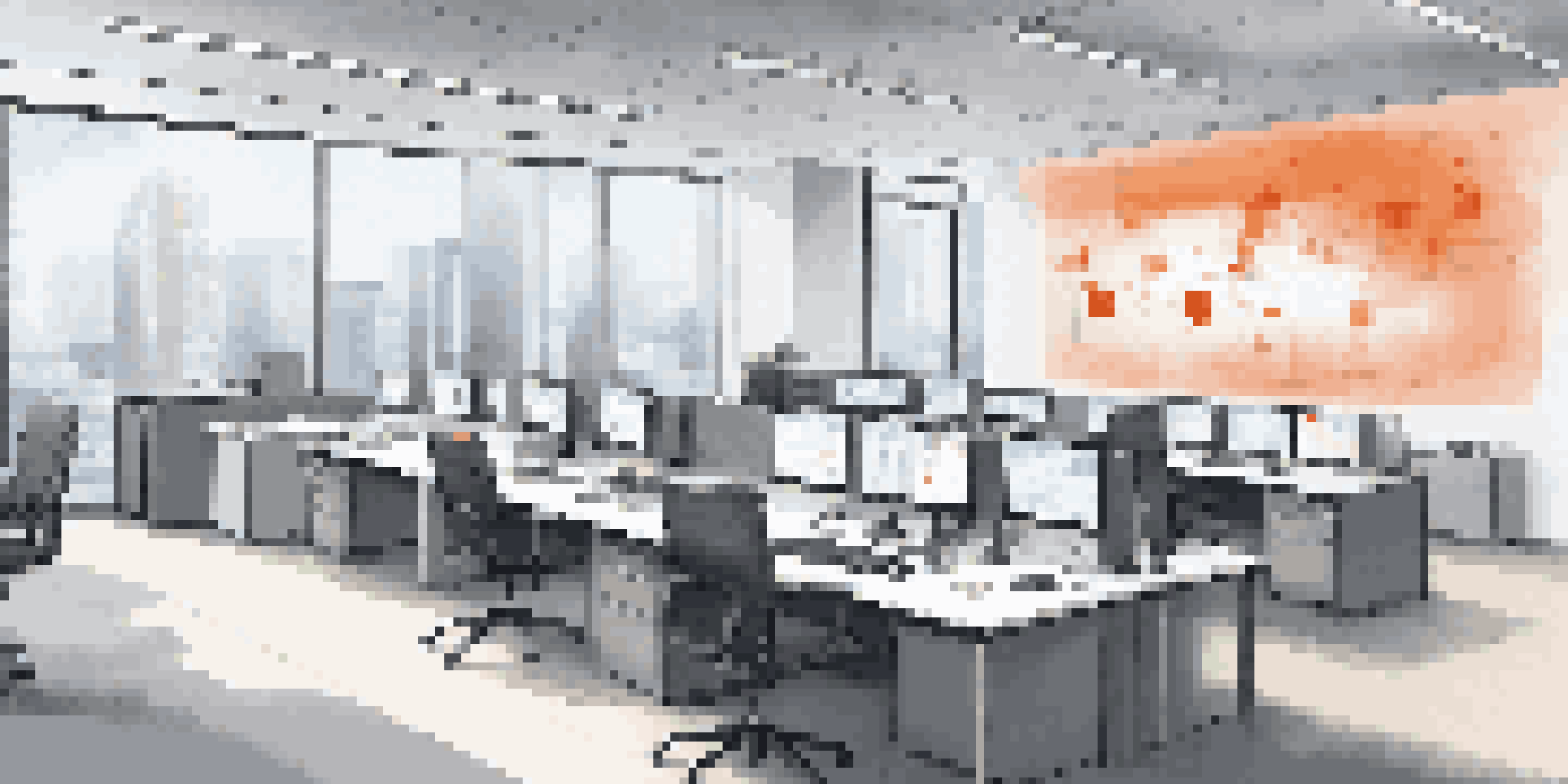 A modern office with screens showing real-time data and alerts, bright natural light, and ergonomic furniture.