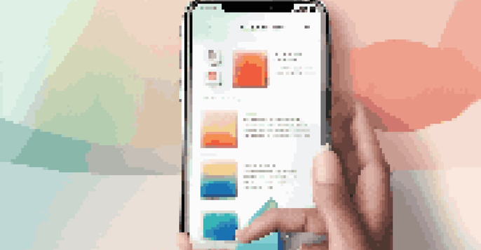 A smartphone displaying a colorful mobile app prototype on a minimalist desk.