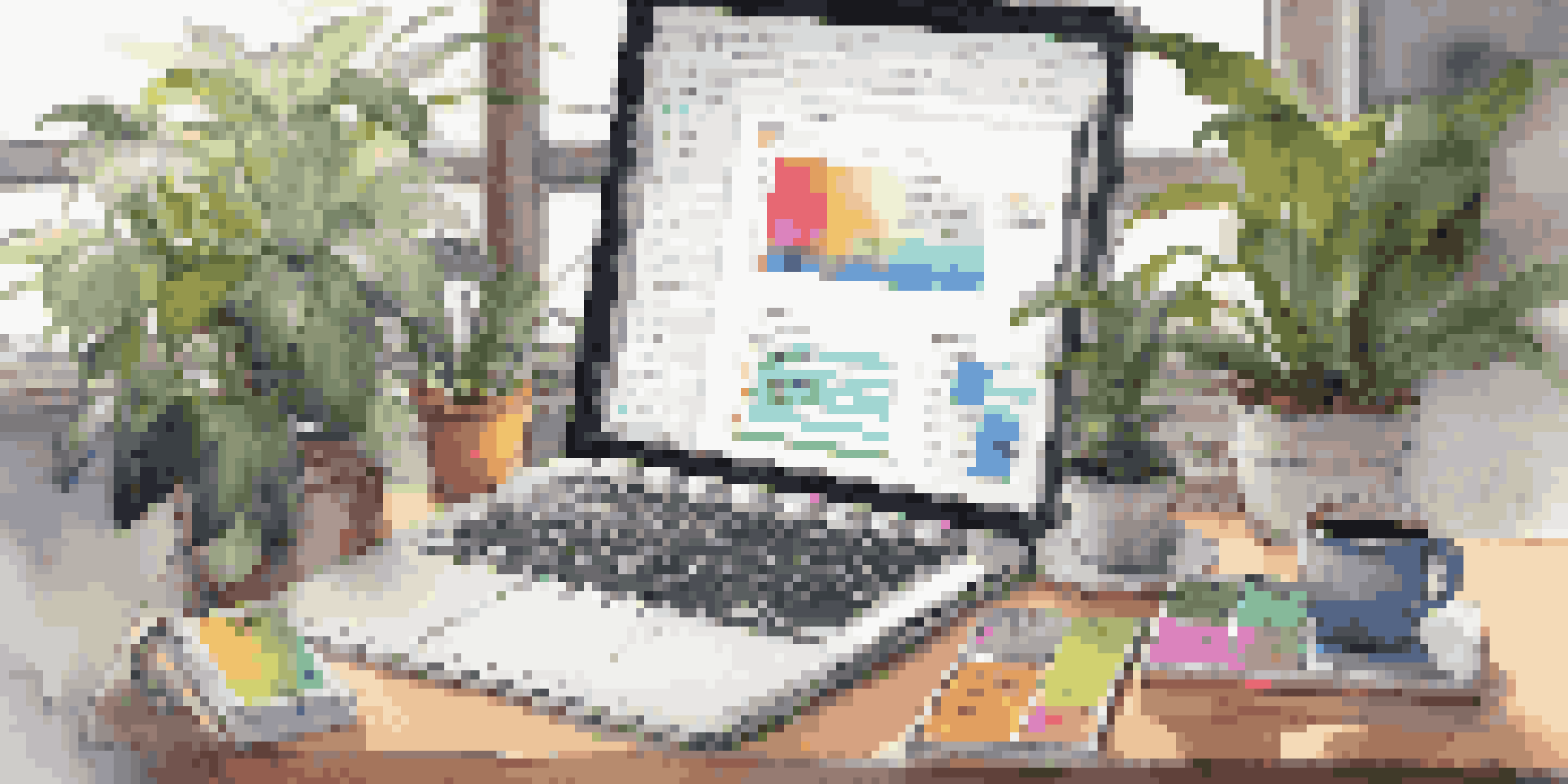 A mobile developer's workspace with a laptop showing code, colorful sticky notes, a cup of coffee, and a smartphone, all in a well-lit room with natural light and plants.
