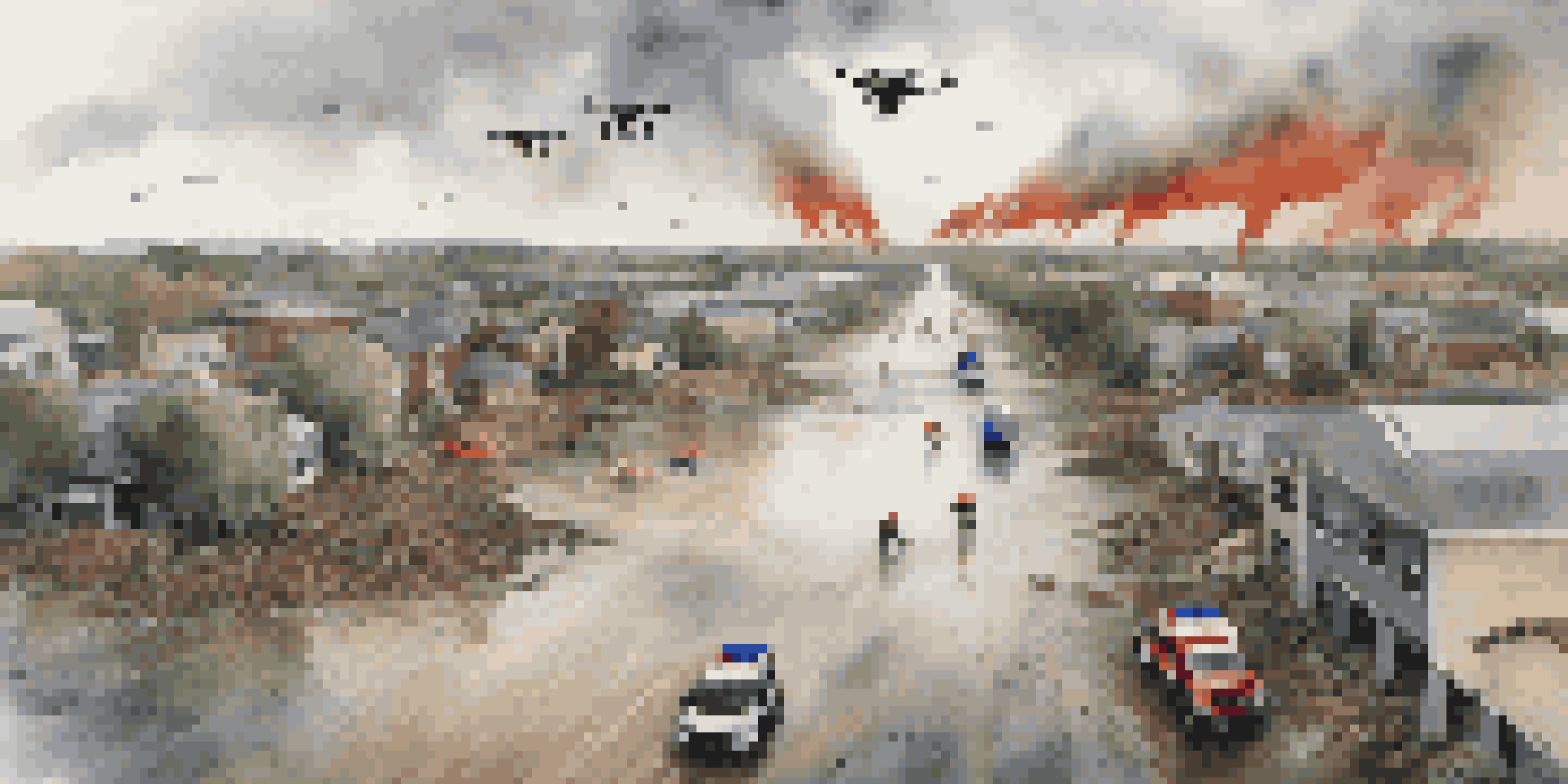 An aerial view of a flood-affected area with drones above and first responders on the ground, under a cloudy sky.