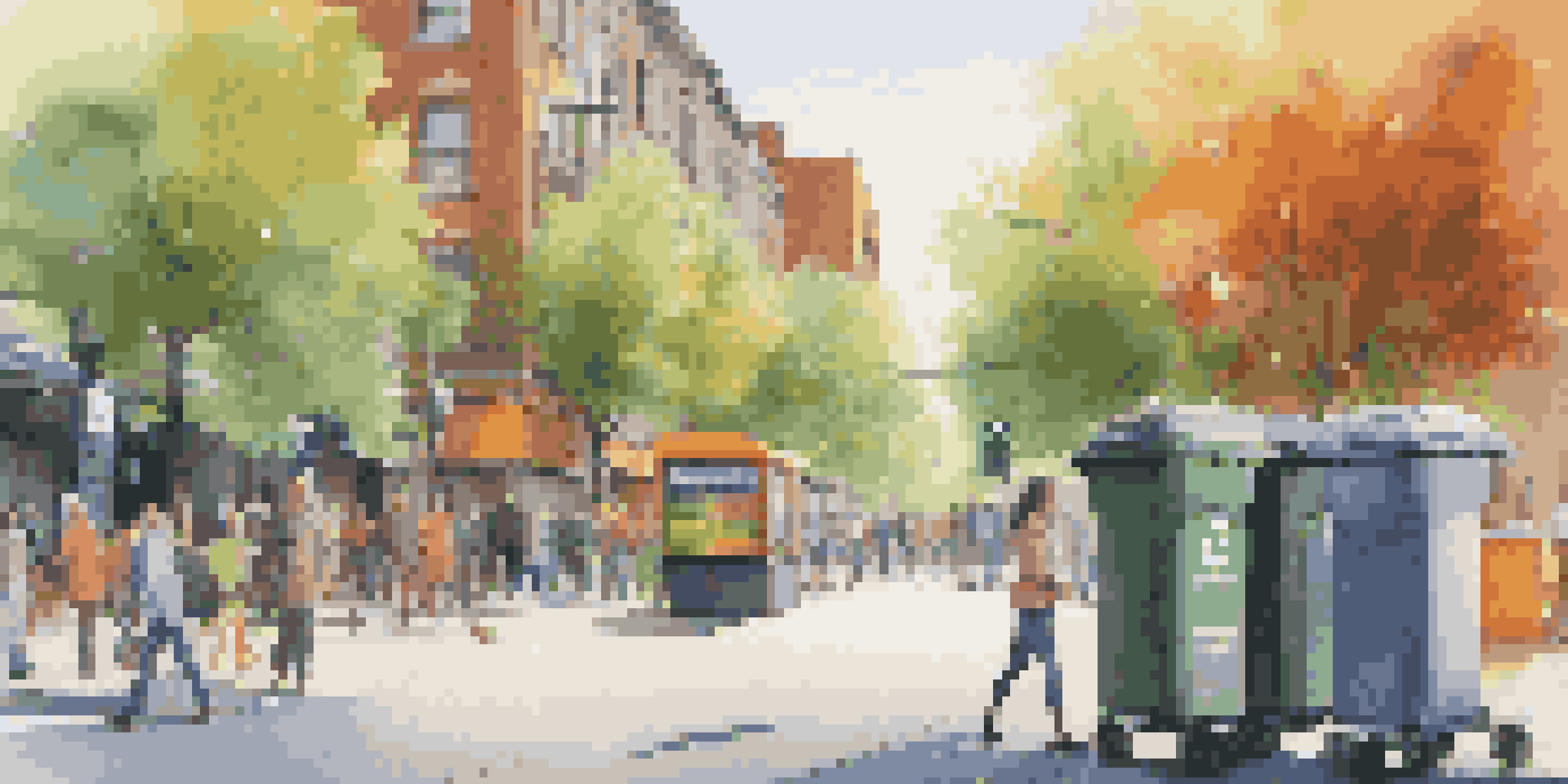 An urban street with smart waste management bins, people walking by in the evening light, and trees.