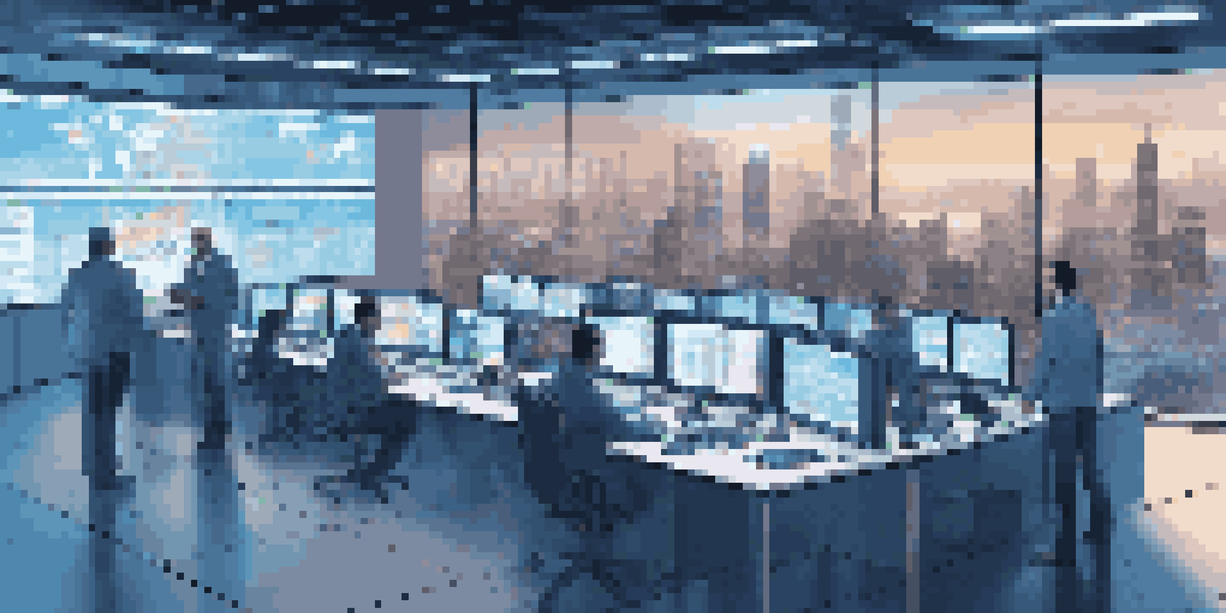 A control room with digital screens showing supply chain metrics, illuminated in blue light, with professionals discussing data.