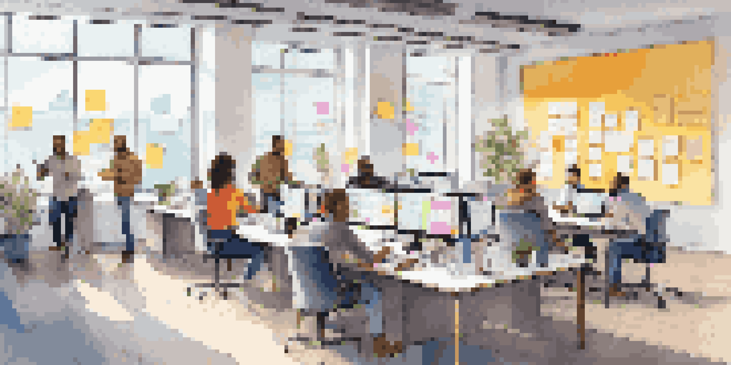 A diverse team in an open office space collaborating on software development, with colorful post-it notes and a whiteboard.