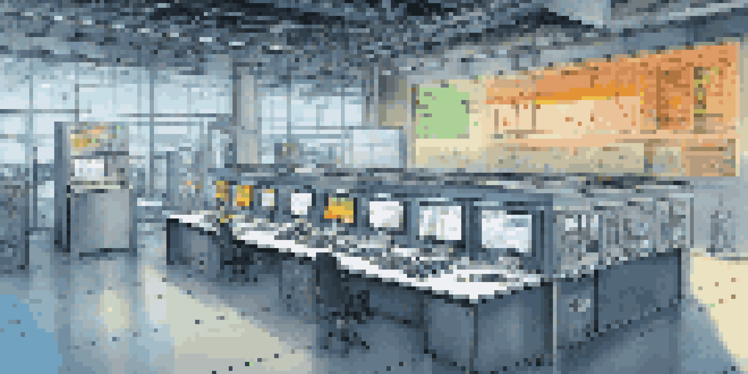 A high-tech industrial workspace with a control panel showing data analytics and predictive maintenance alerts, illuminated by bright LED lights.