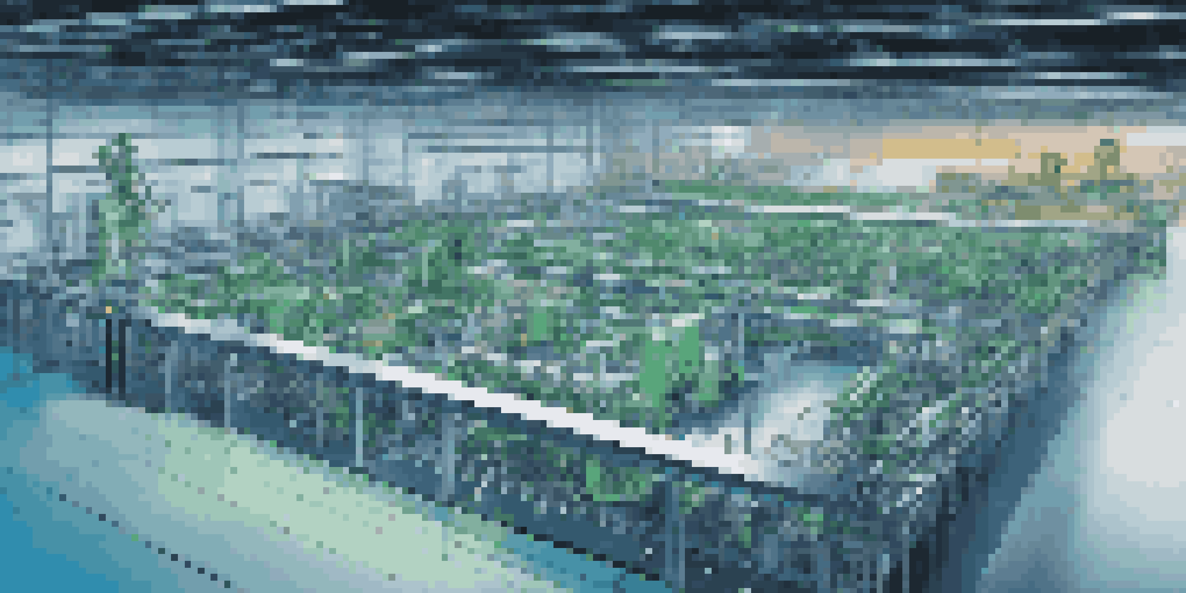 A digital twin model of a manufacturing facility with robotic arms and machinery, featuring real-time data analytics on a large screen.