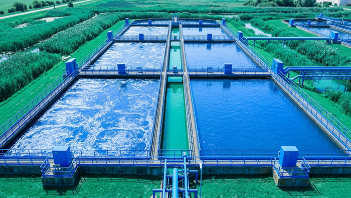 Outdoor aerial view of a municipal wastewater treatment plant with aeration basins and infrastructure