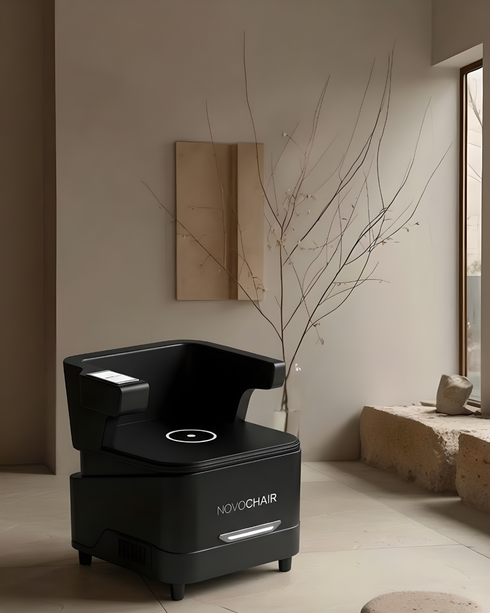 NovoChair from Lyfe Nordic, a black pelvic floor treatment chair in a modern wellness and clinic setting.