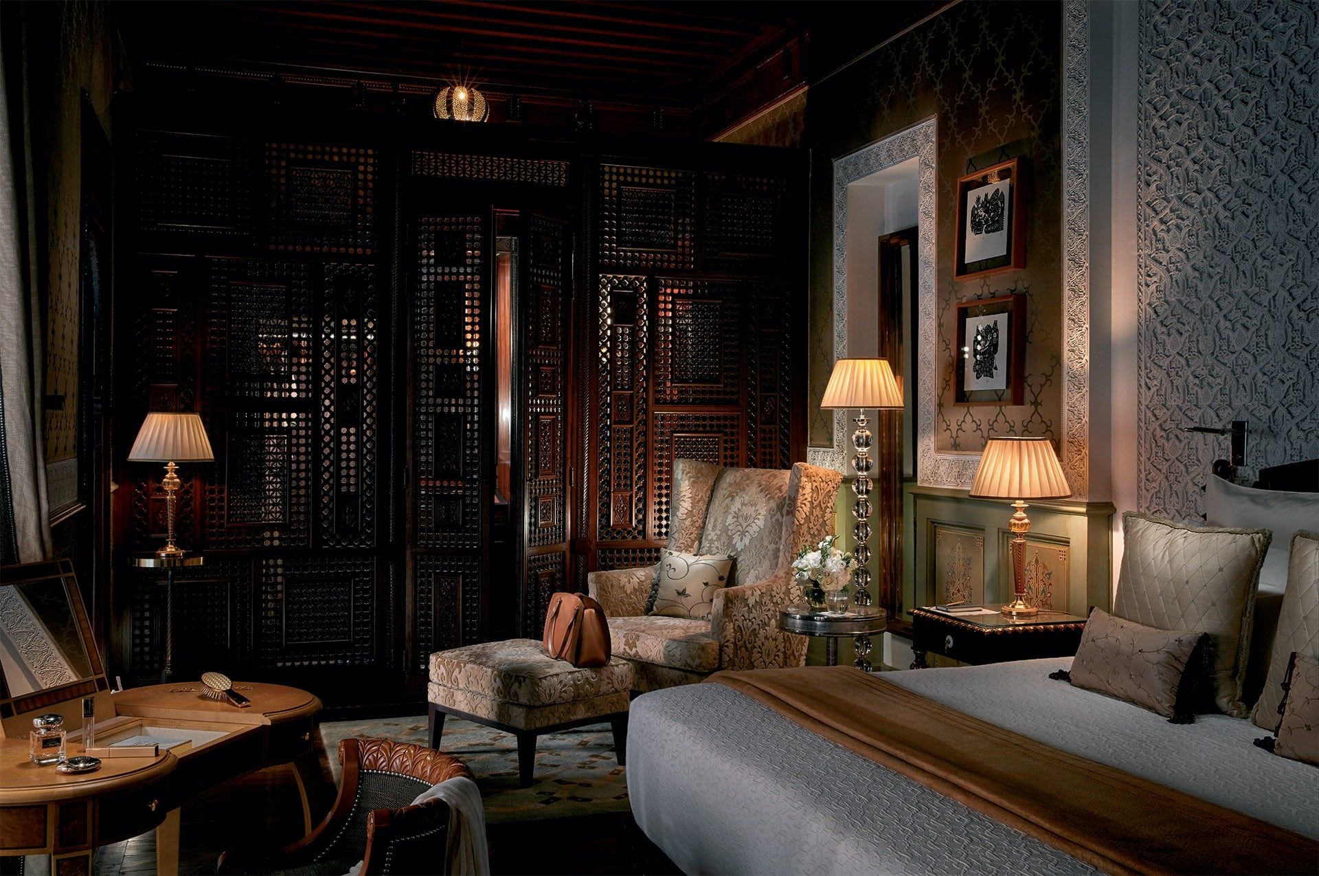 A riad bedroom with carved-cedar mashrabiya screens