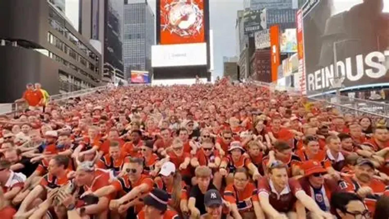 Norway fans performing their famous row chant in Times Square New York