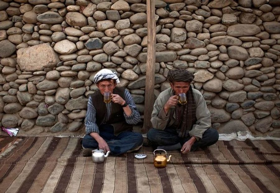 Two Afghan travellers meet for tea