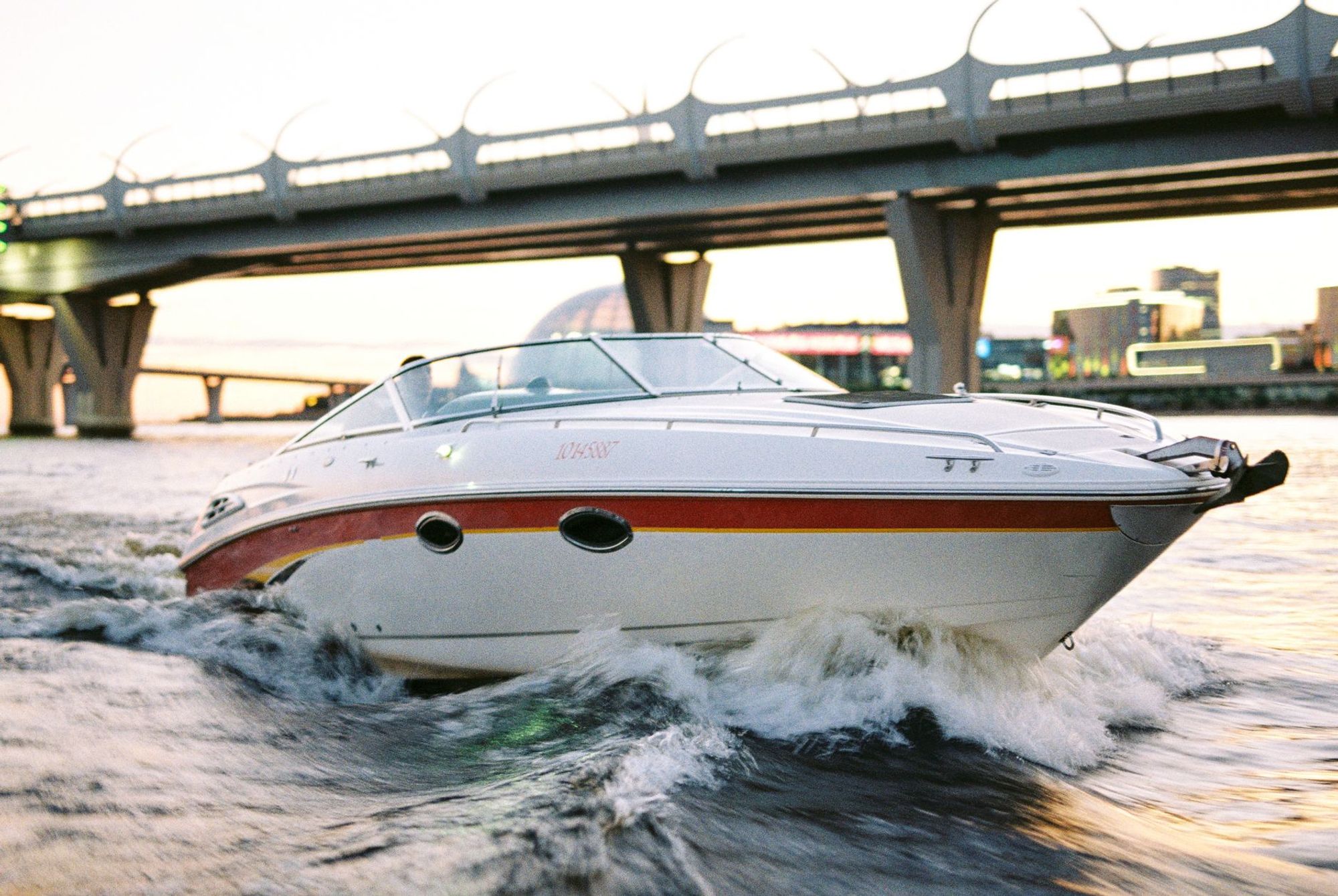 White recreational motorboat travelling on the water