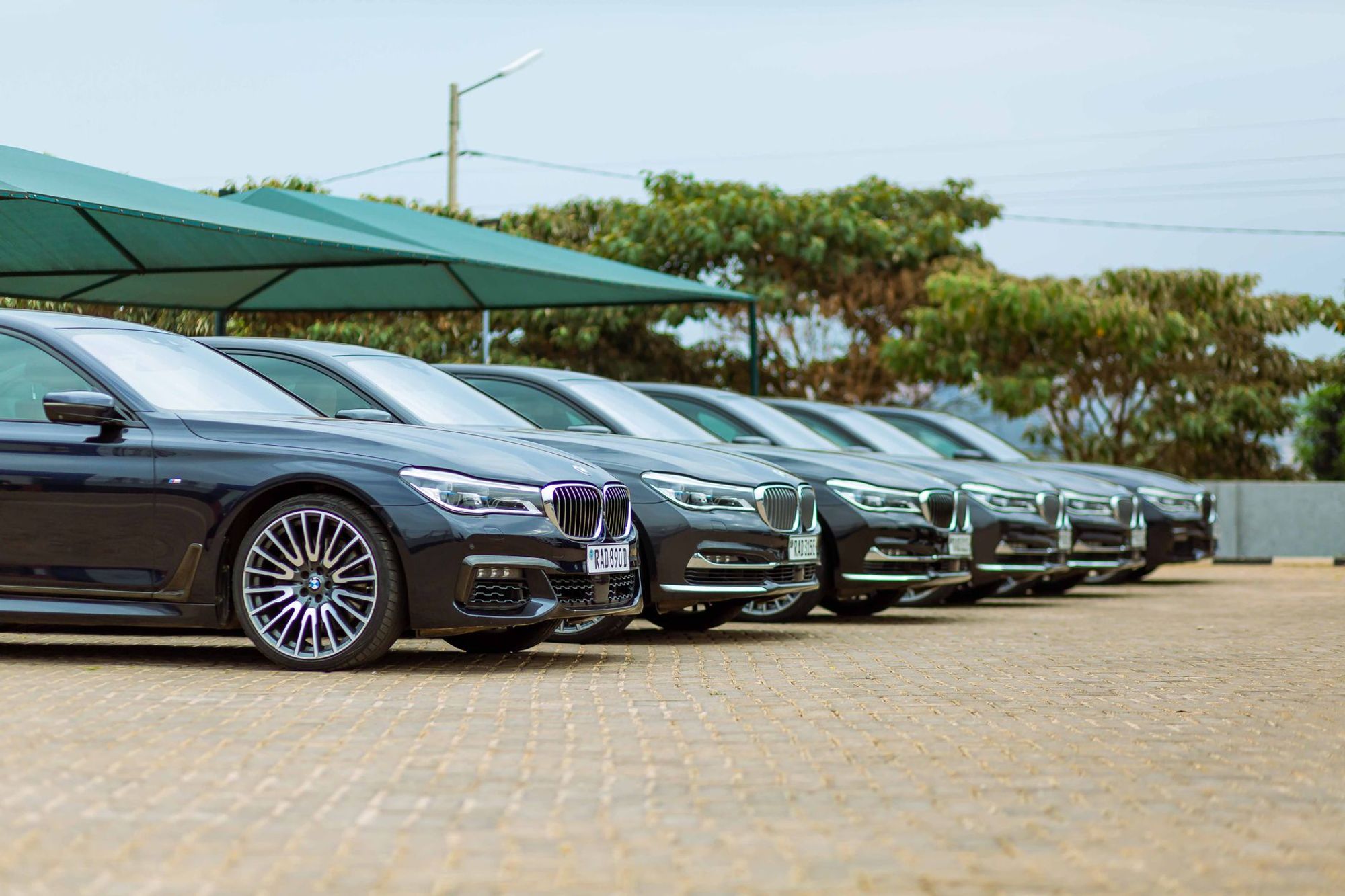 Luxury sedans parked in a row outdoors