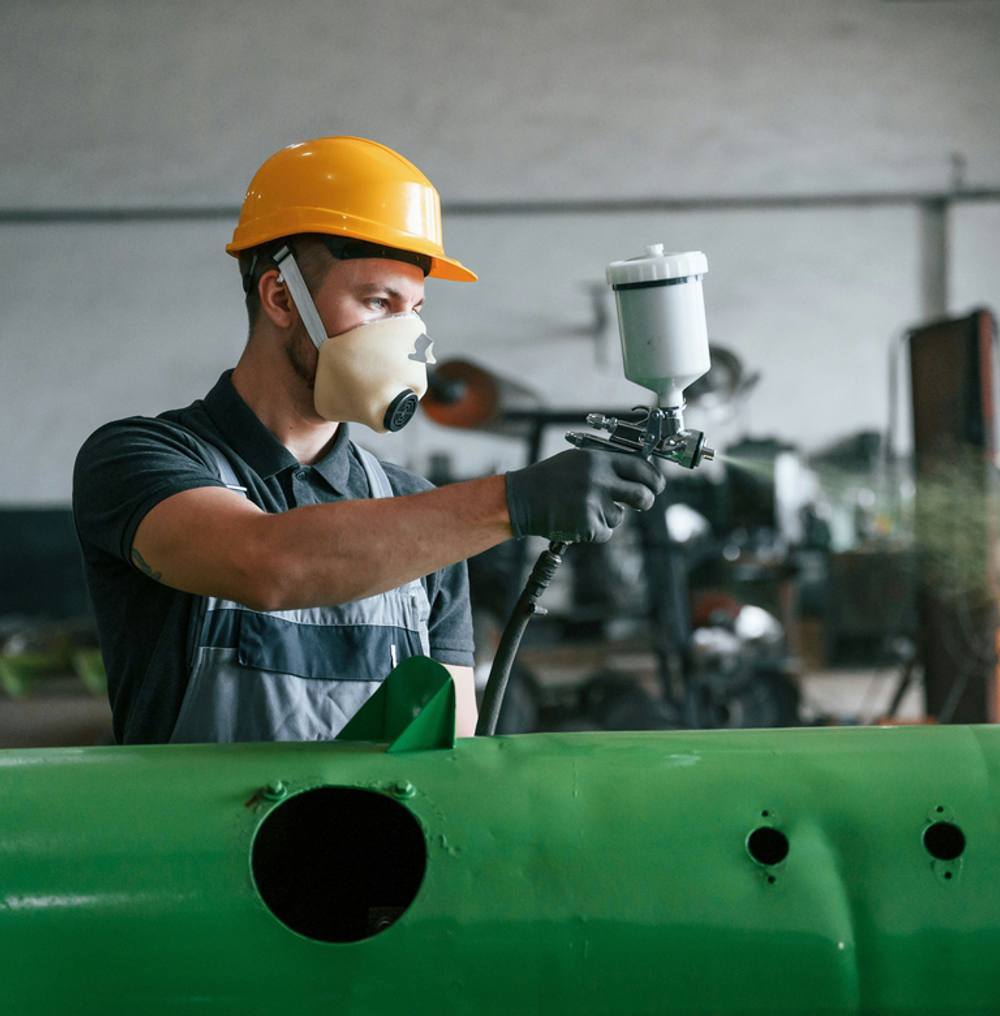 Manufacturing worker with safety equipment